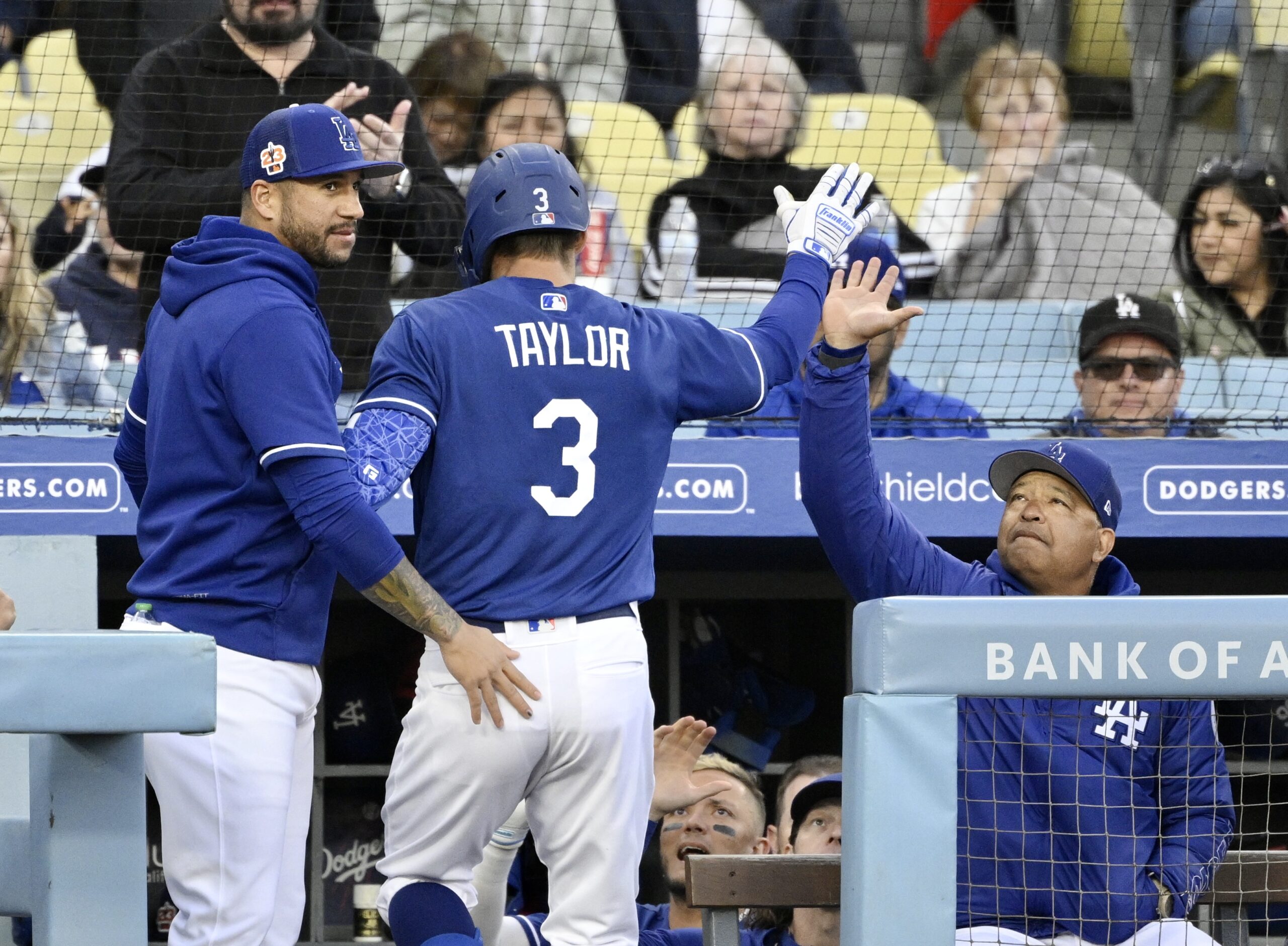 Chris Taylor #3 of the Los Angeles Dodgers high fives...