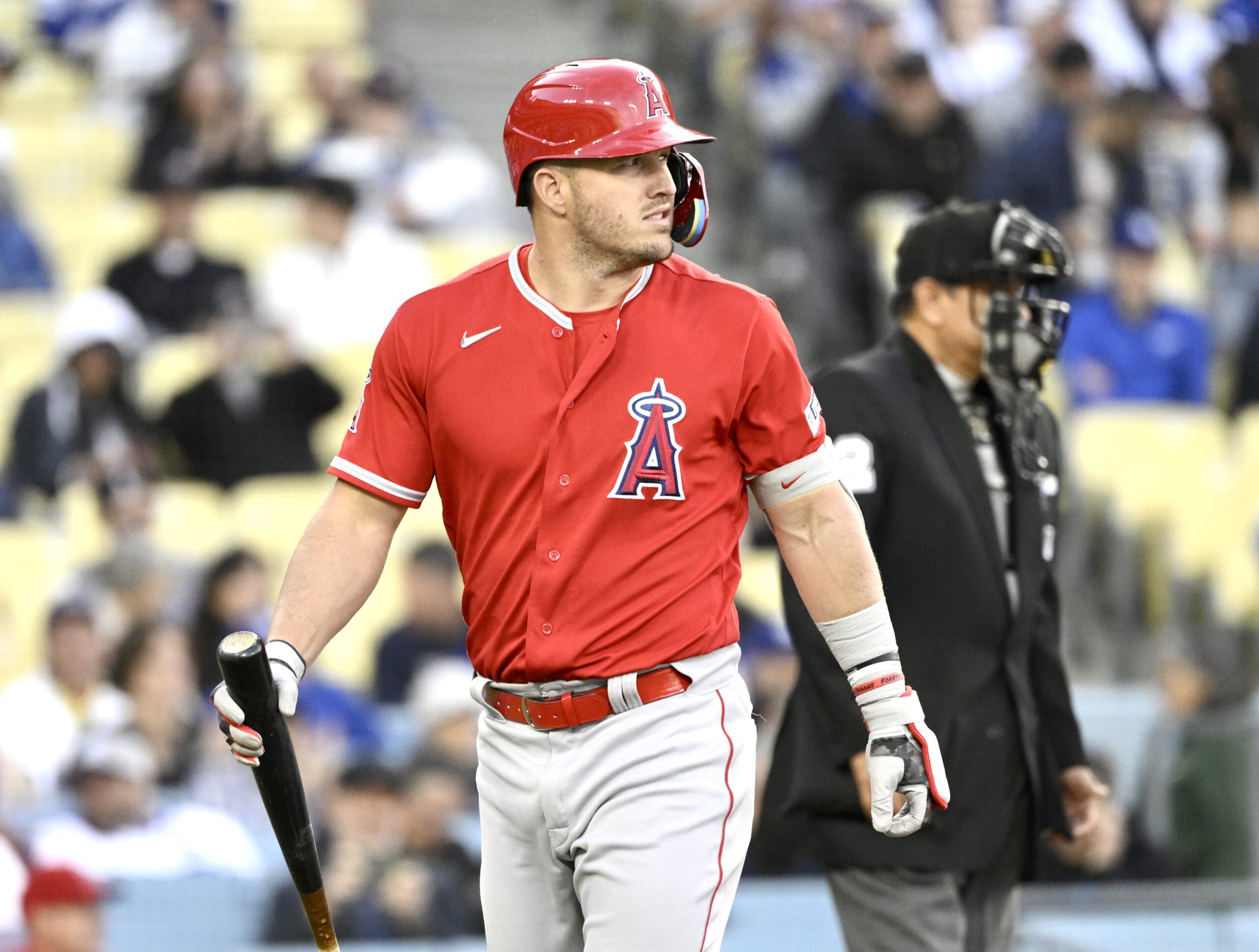 Mike Trout #27 of the Los Angeles Angels reacts after...