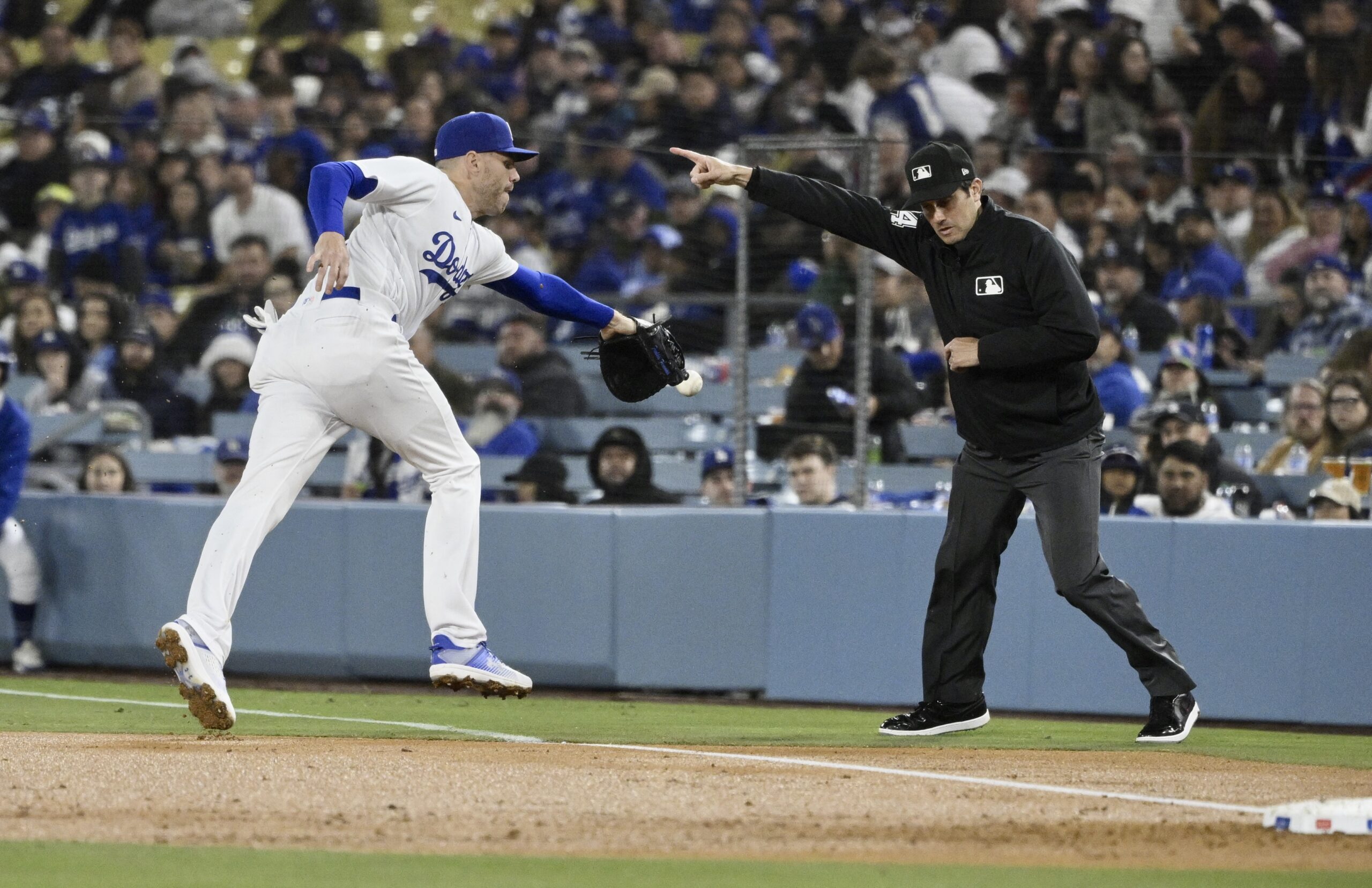 Dodgers first baseman Freddie Freeman can’t reach a ball hit...