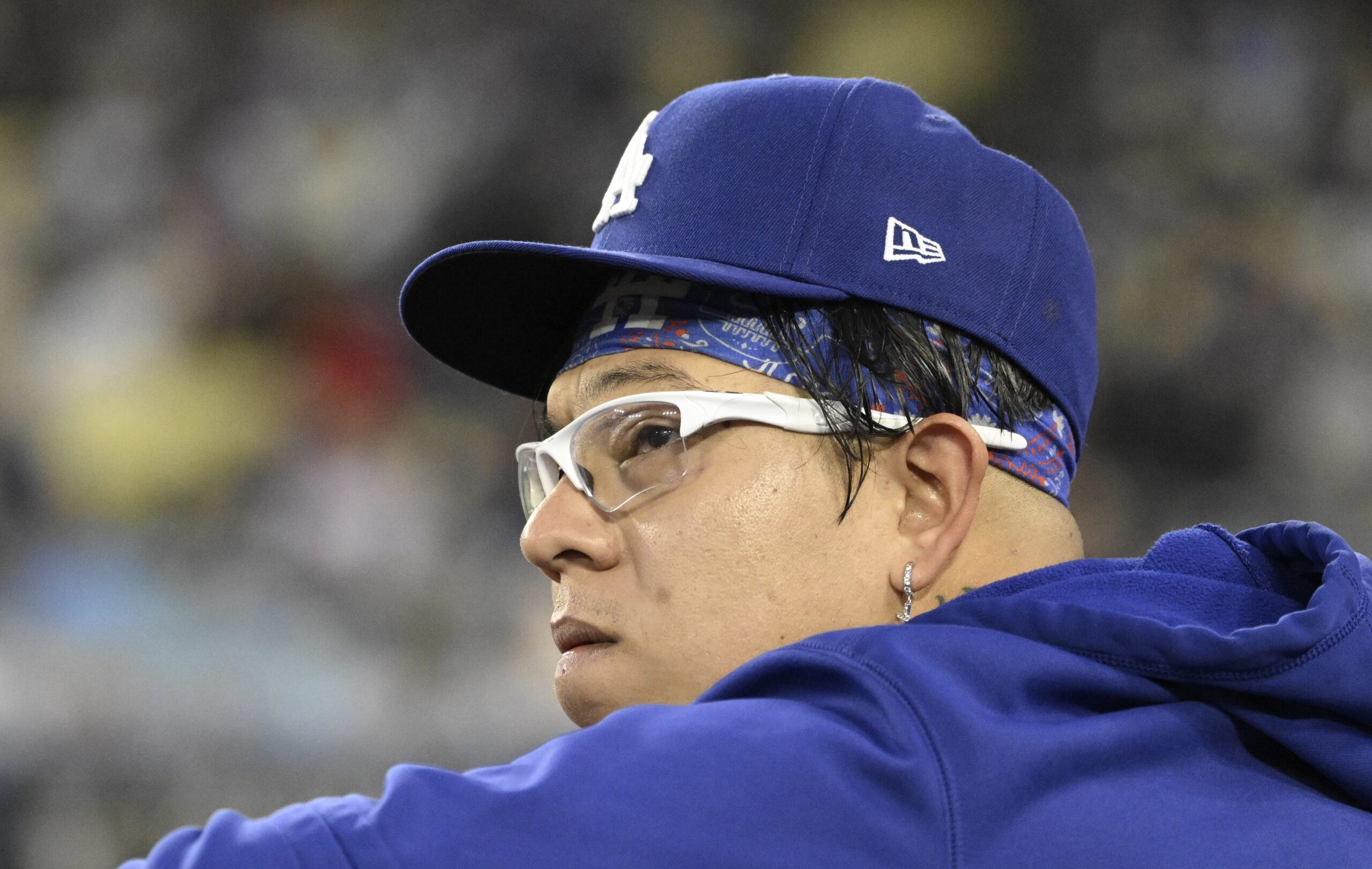 Dodgers pitcher Julio Urias watches from the dugout during their...