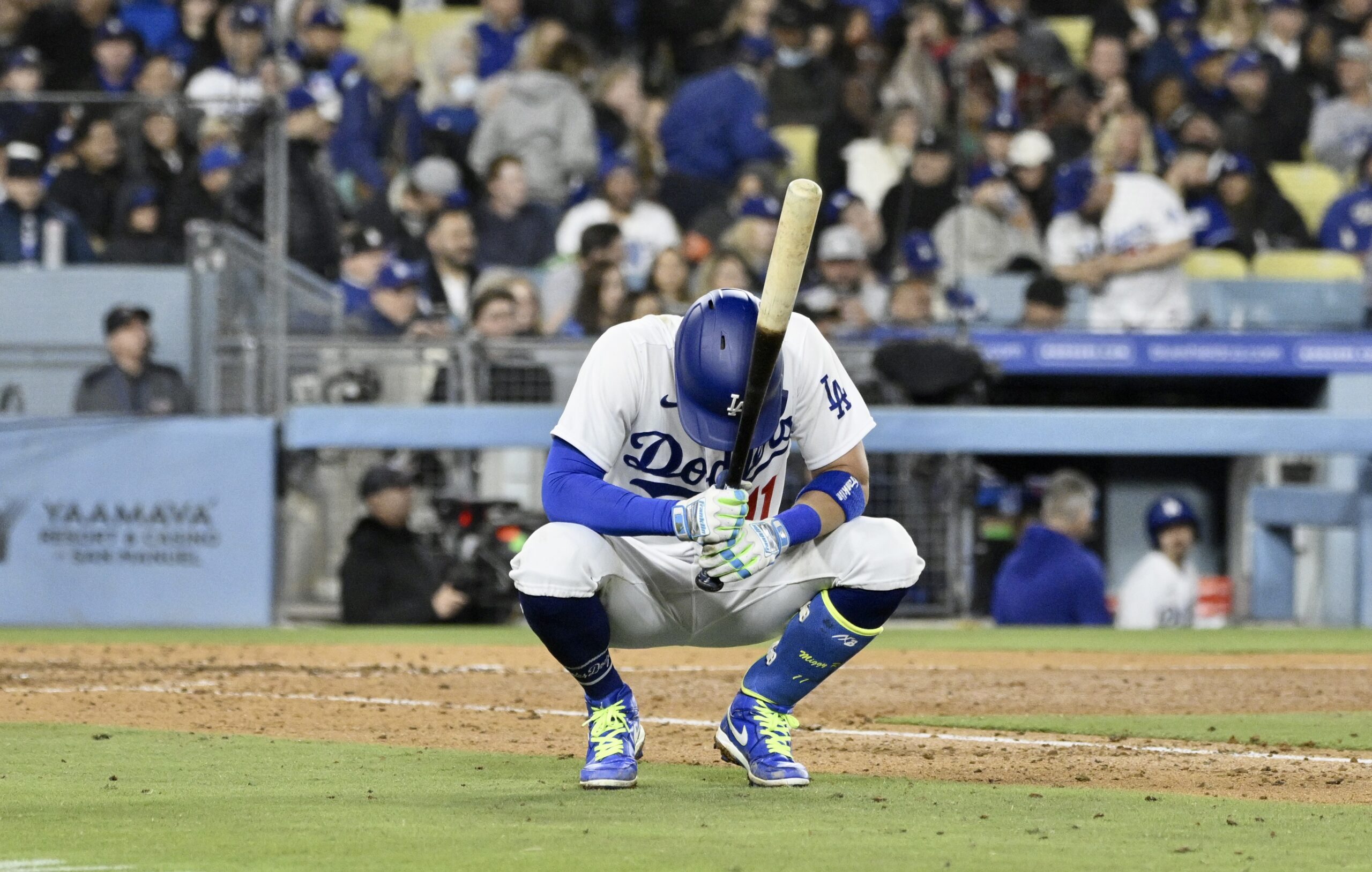 The Dodgers’ Miguel Rojas shows his frustration after lining out...