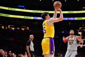 May 22, 2023; Los Angeles, California, USA; Los Angeles Lakers guard Austin Reaves (15) shoots a three point basket against the Denver Nuggets during the fourth quarter in game four of the Western Conference Finals for the 2023 NBA playoffs at Crypto.com Arena. Mandatory Credit: Gary A. Vasquez-USA TODAY Sports