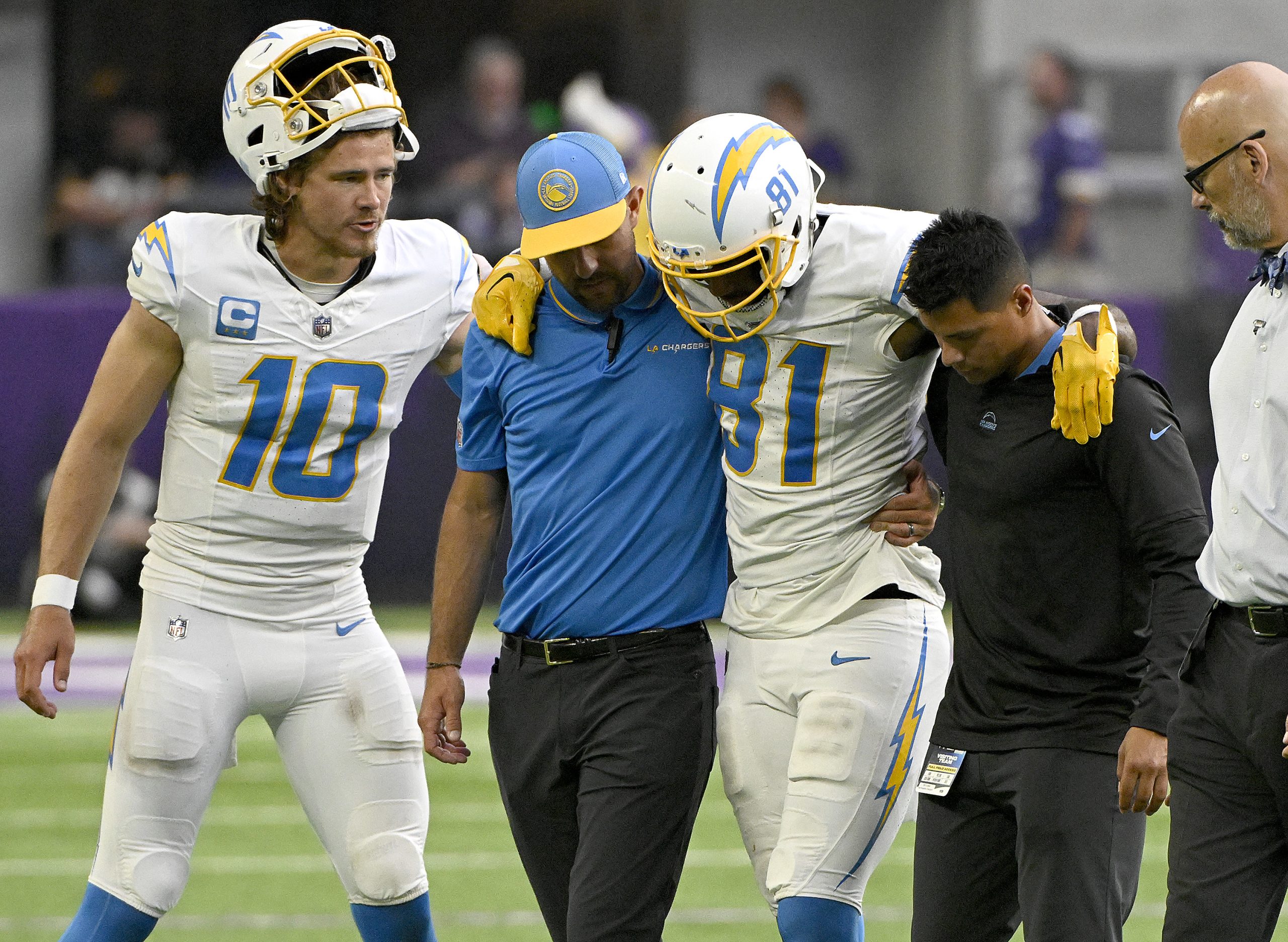 Justin Herbert of the Los Angeles Chargers watches as Los...