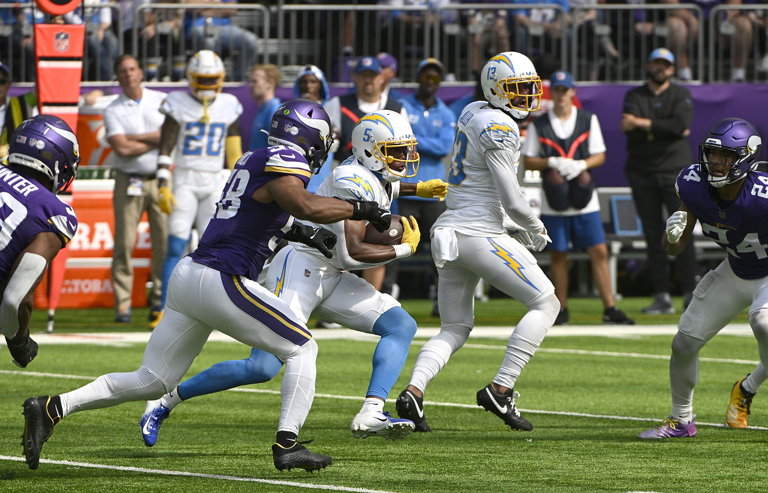 Joshua Palmer of the Los Angeles Chargers pursues Jordan Hicks...