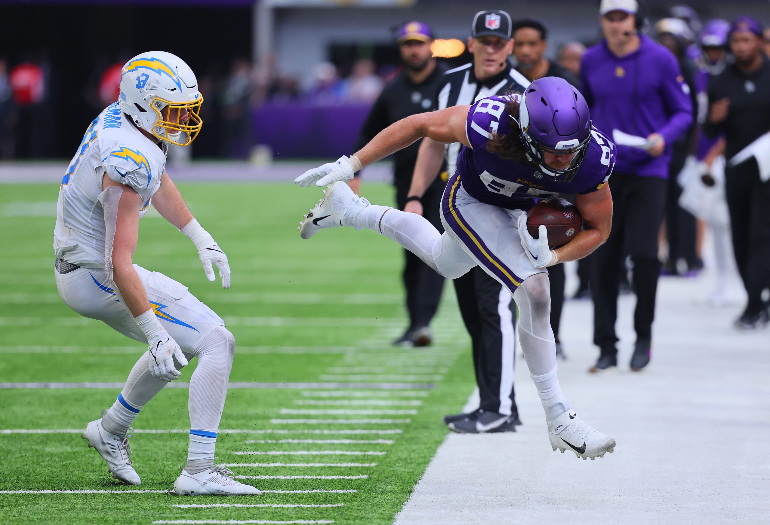 T.J. Hockenson of the Minnesota Vikings steps out of bounds...