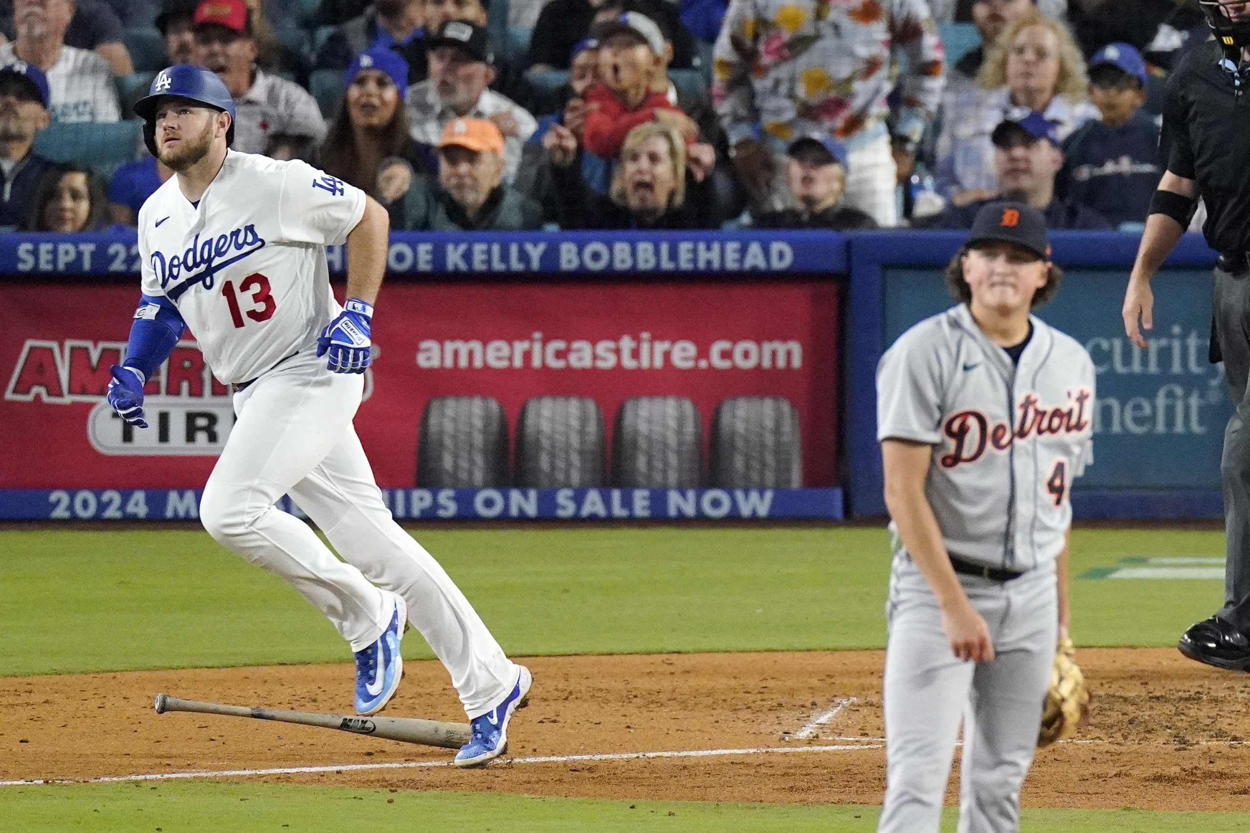 The Dodgers’ Max Muncy, left, begins to run the bases...