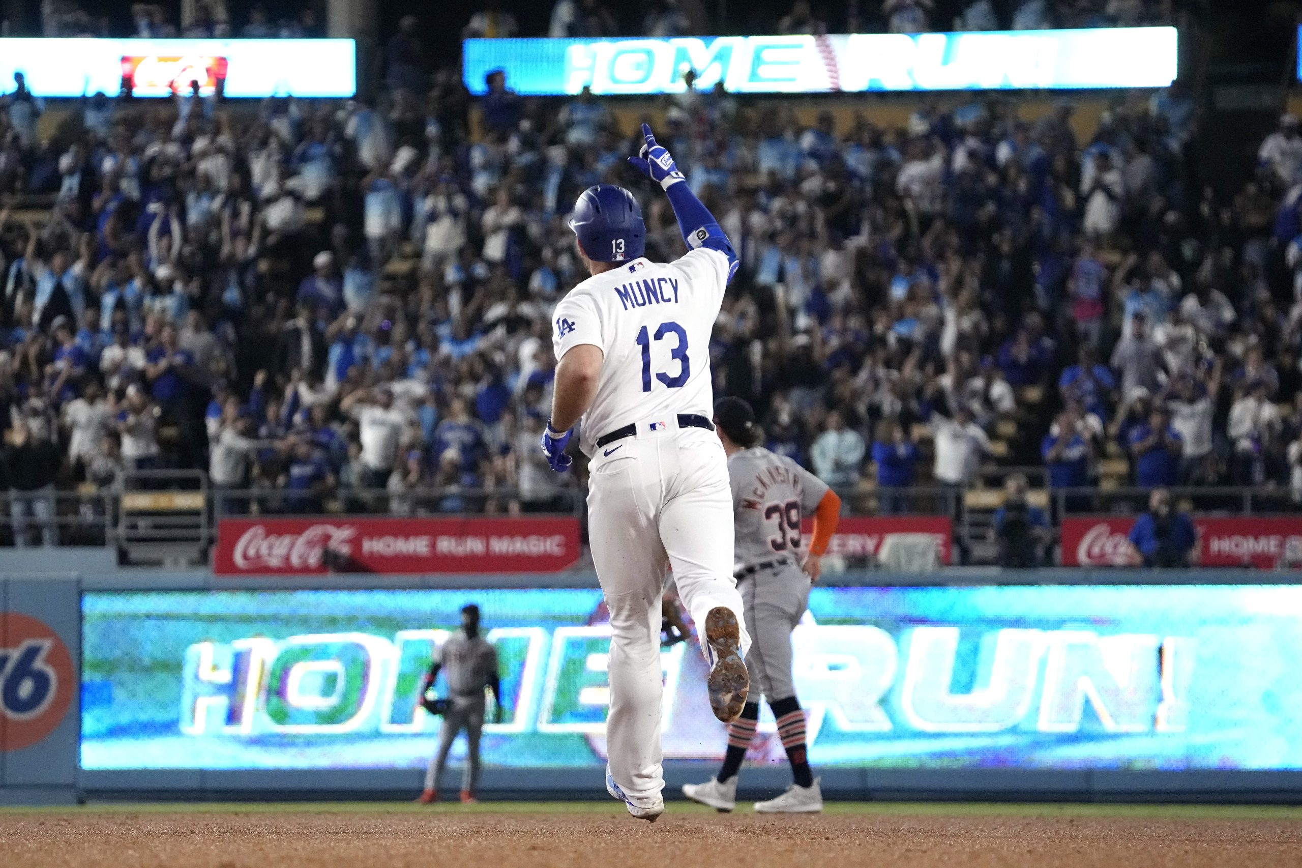 The Dodgers’ Max Muncy gestures as he circles the bases...