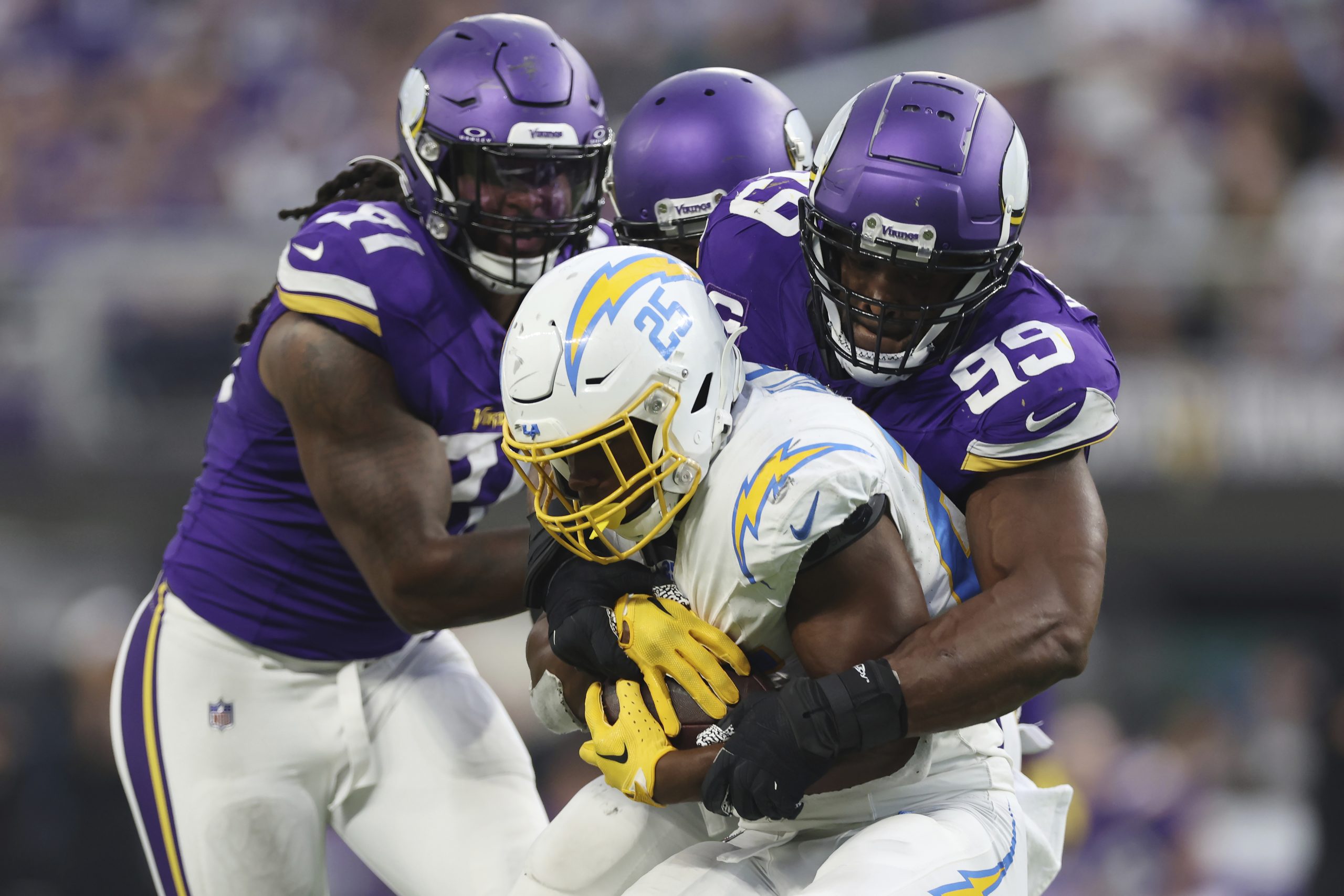 Los Angeles Chargers running back Joshua Kelley is tackled by...
