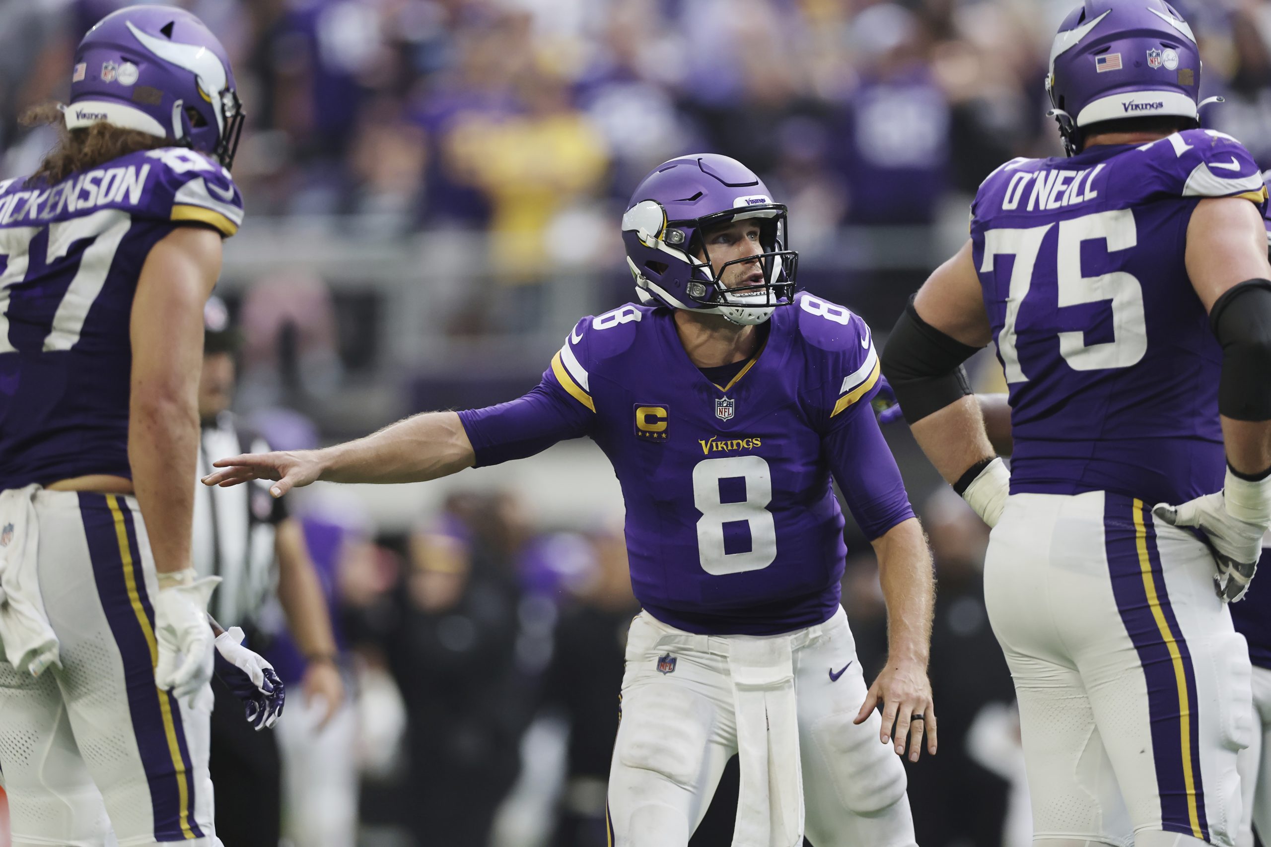 Minnesota Vikings quarterback Kirk Cousins tries to set up a...