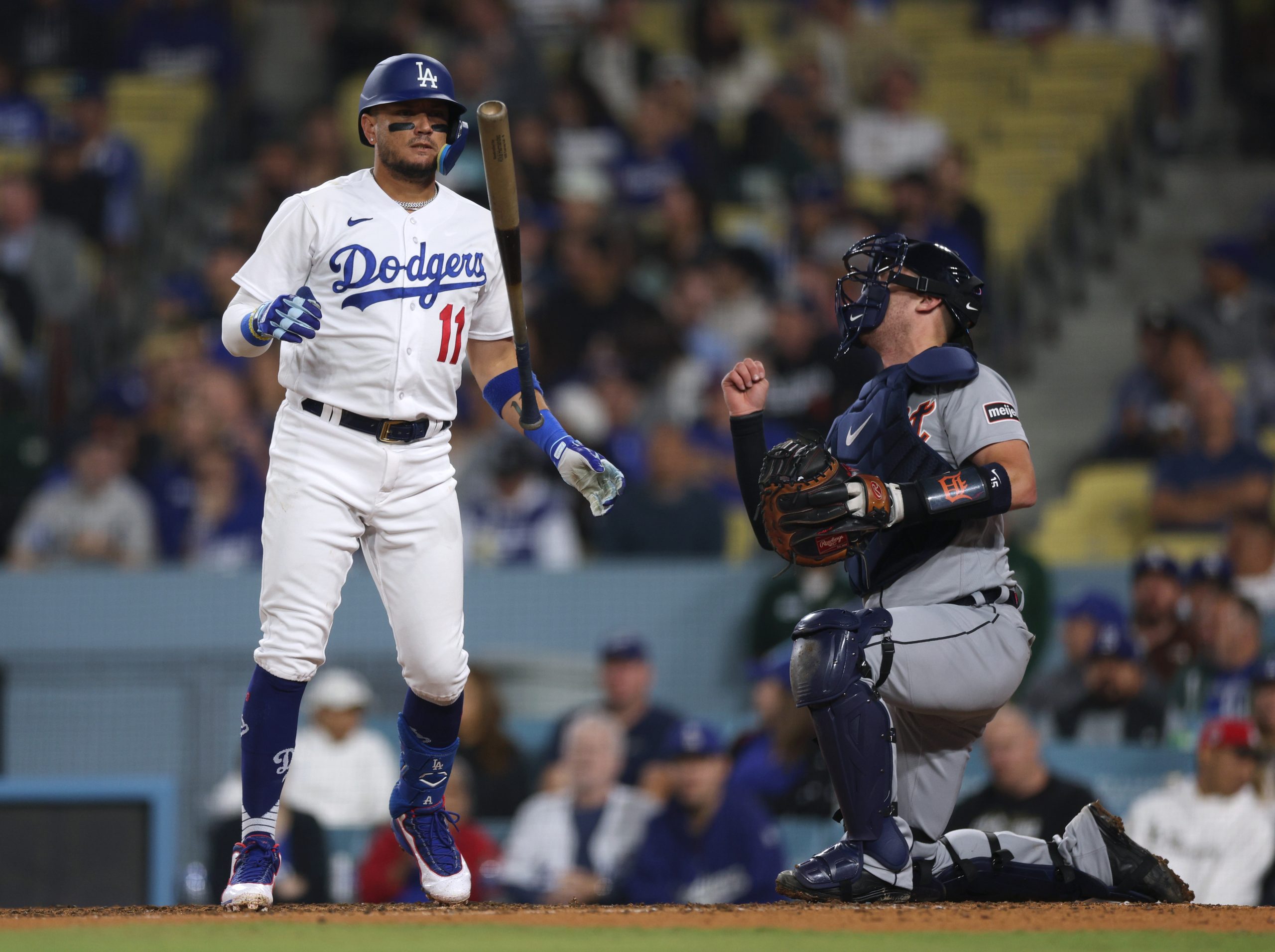 The Dodgers’ Miguel Rojas reacts to a strike in front...