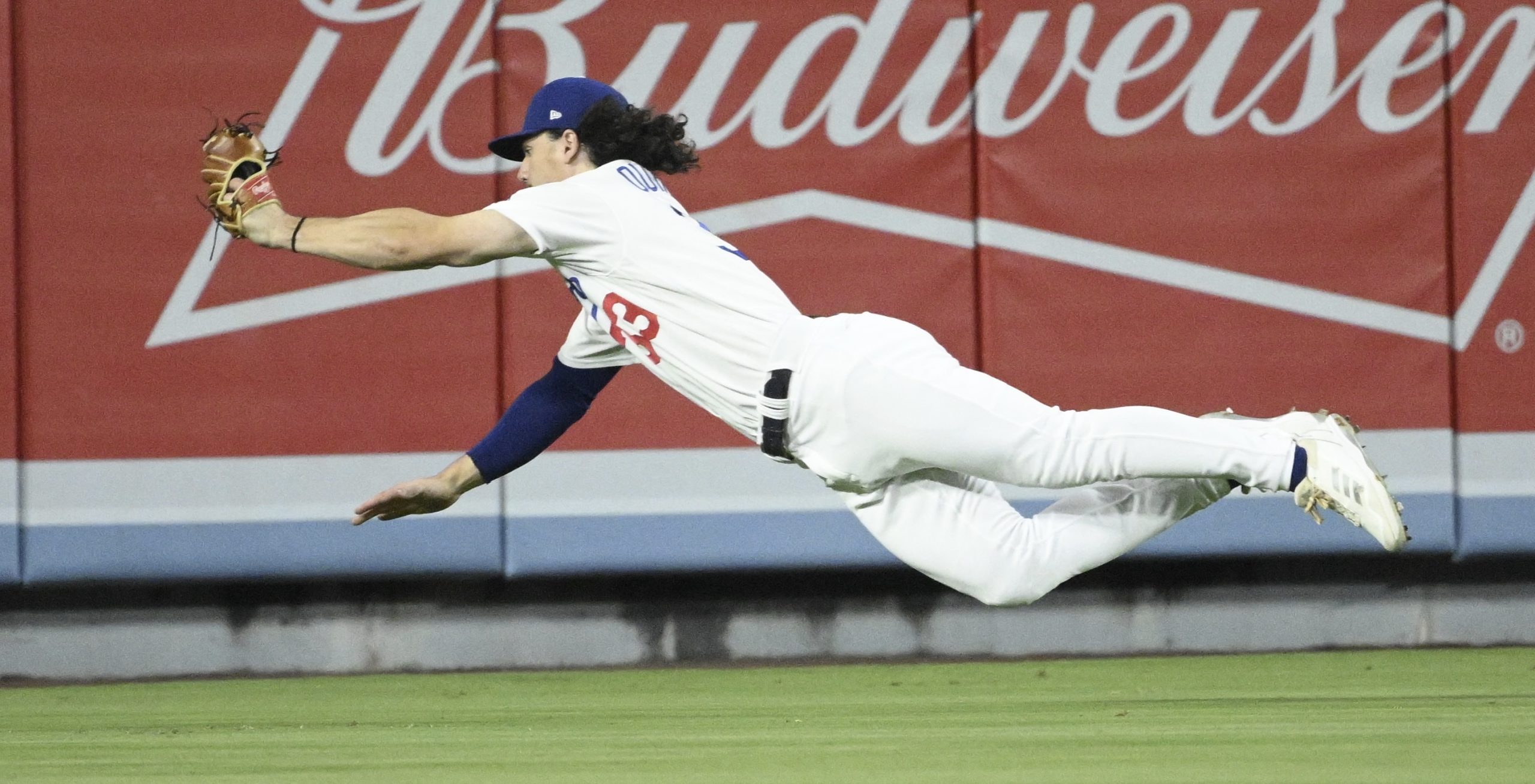 Dodgers center fielder James Outman makes a diving catch on...
