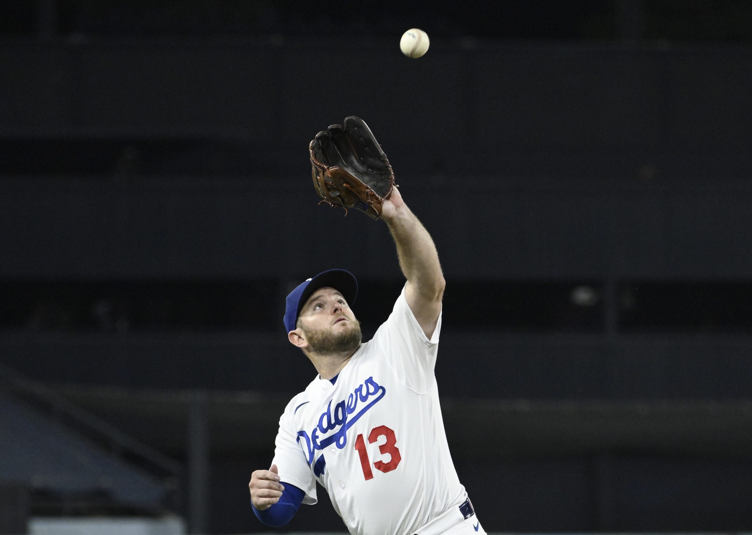 Dodgers third baseman Max Muncy makes a catch on a...