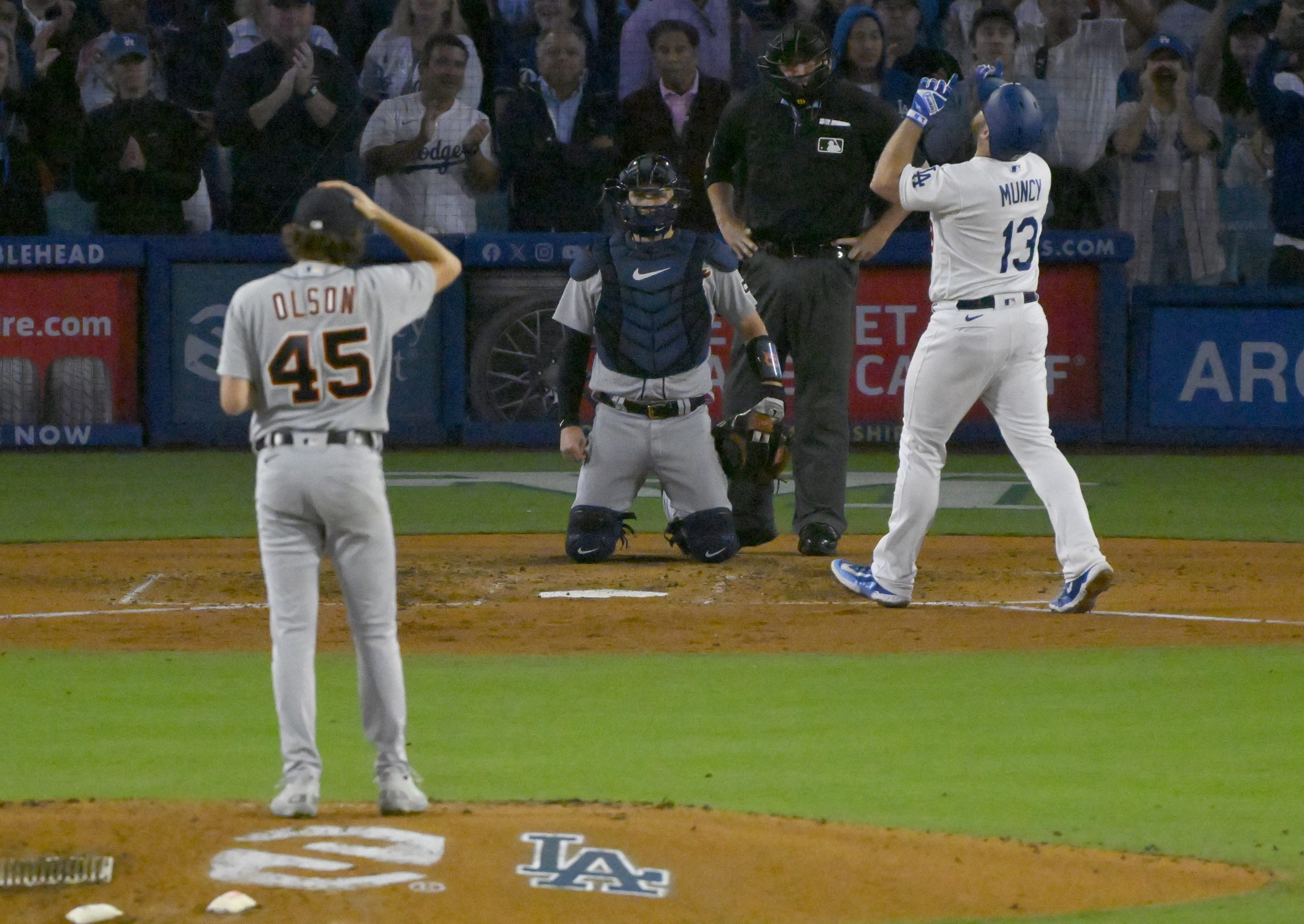 The Dodgers’ Max Muncy points to the sky as he...