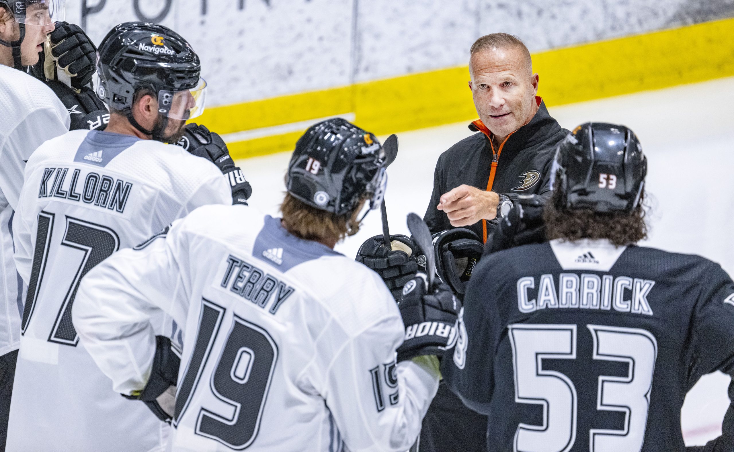 New Ducks head coach Greg Cronin speaks with players on...