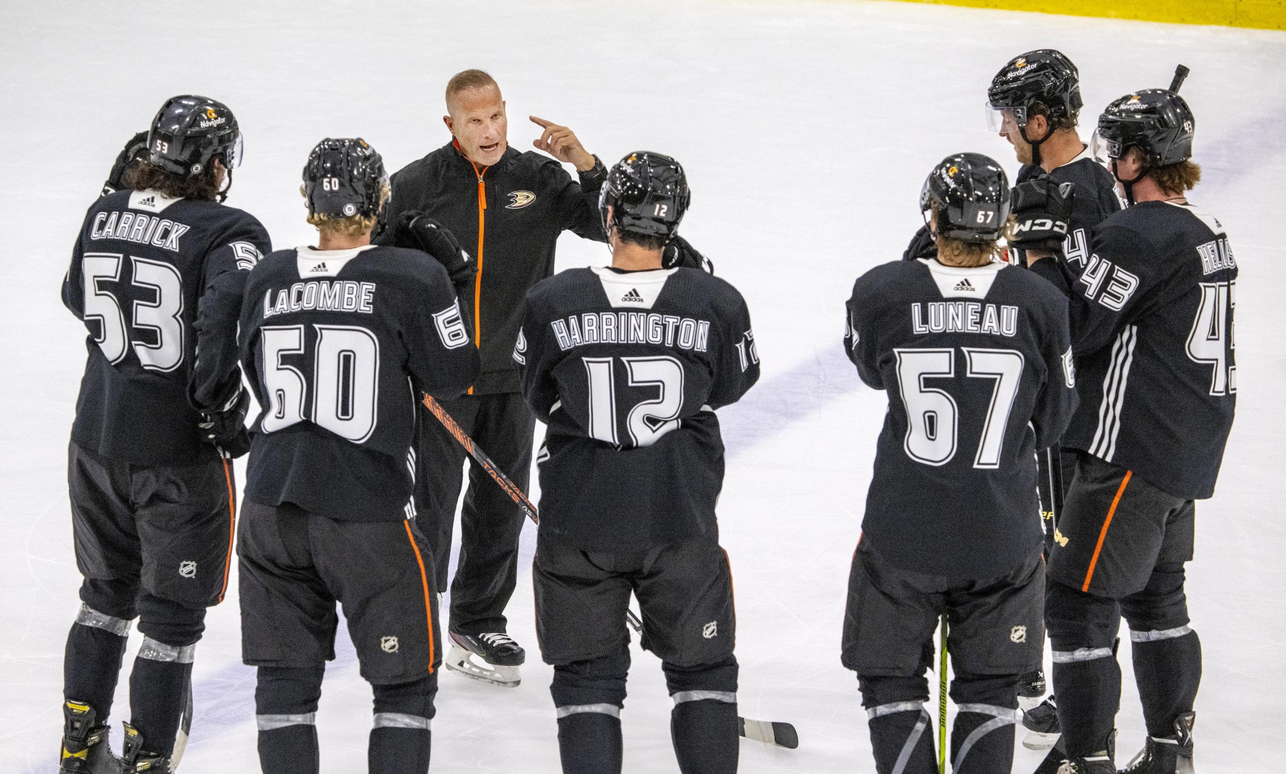 New Ducks head coach Greg Cronin speaks with players on...