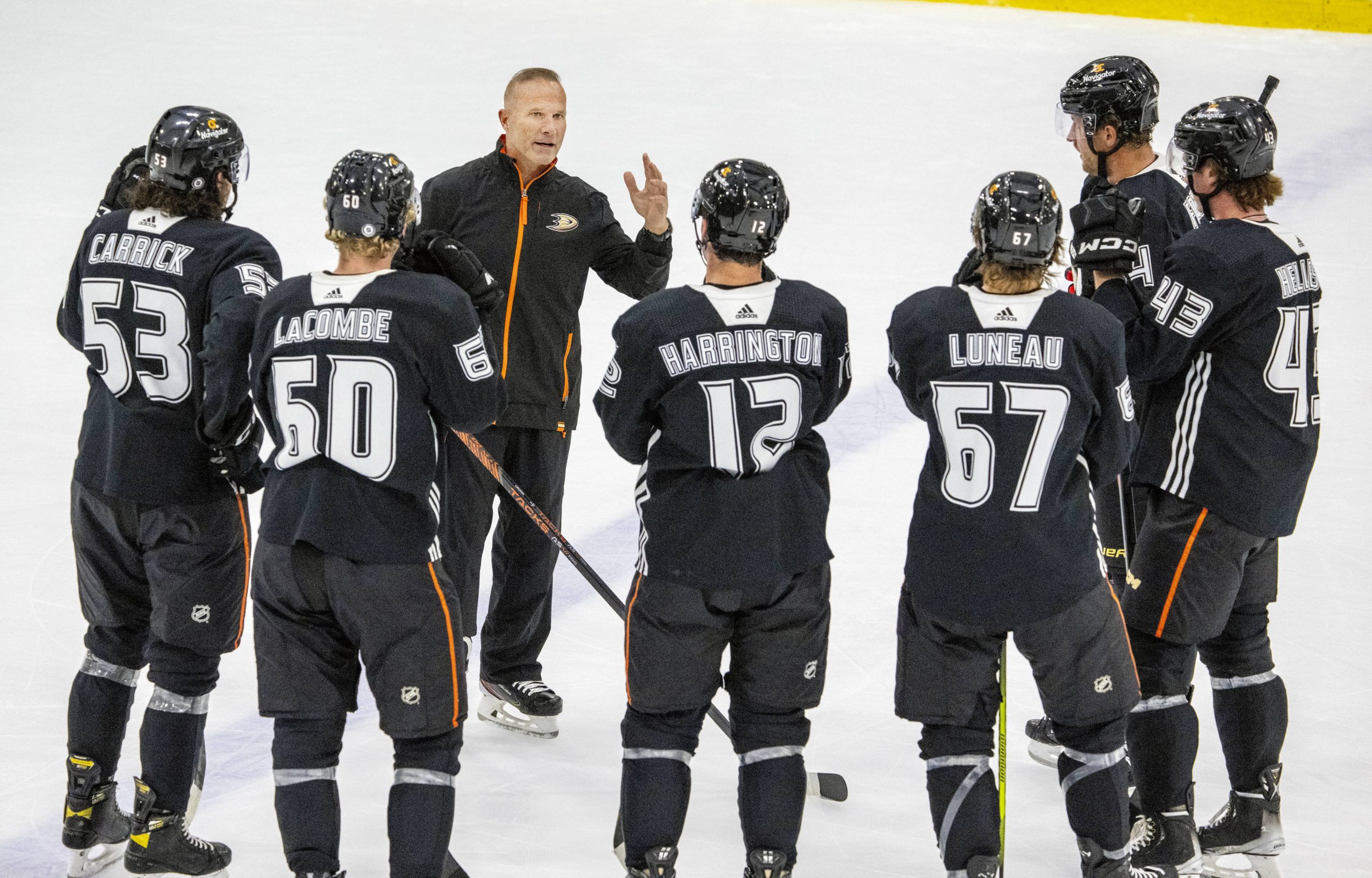 New Ducks head coach Greg Cronin speaks with players on...