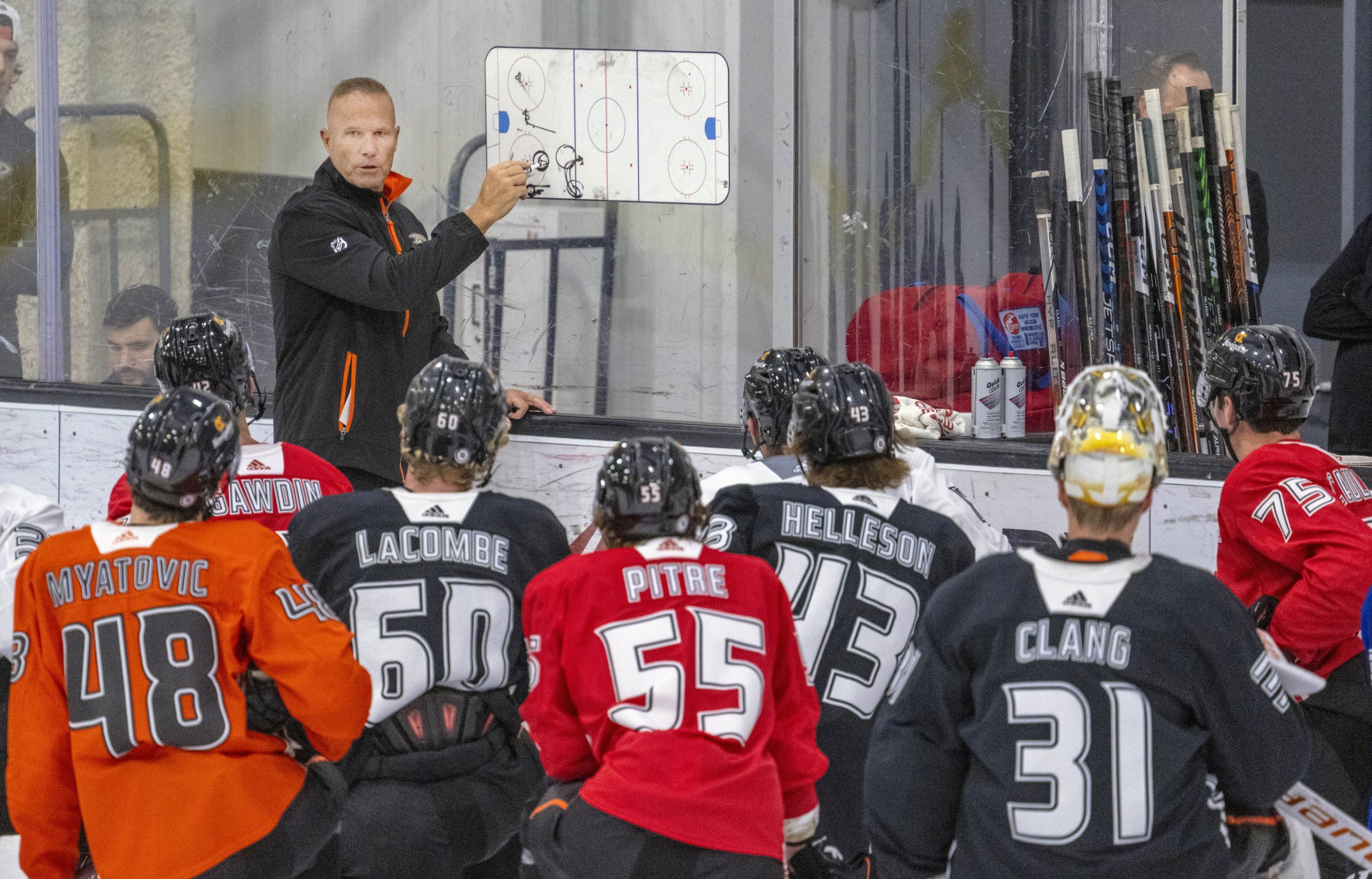 New Ducks head coach Greg Cronin speaks with players on...