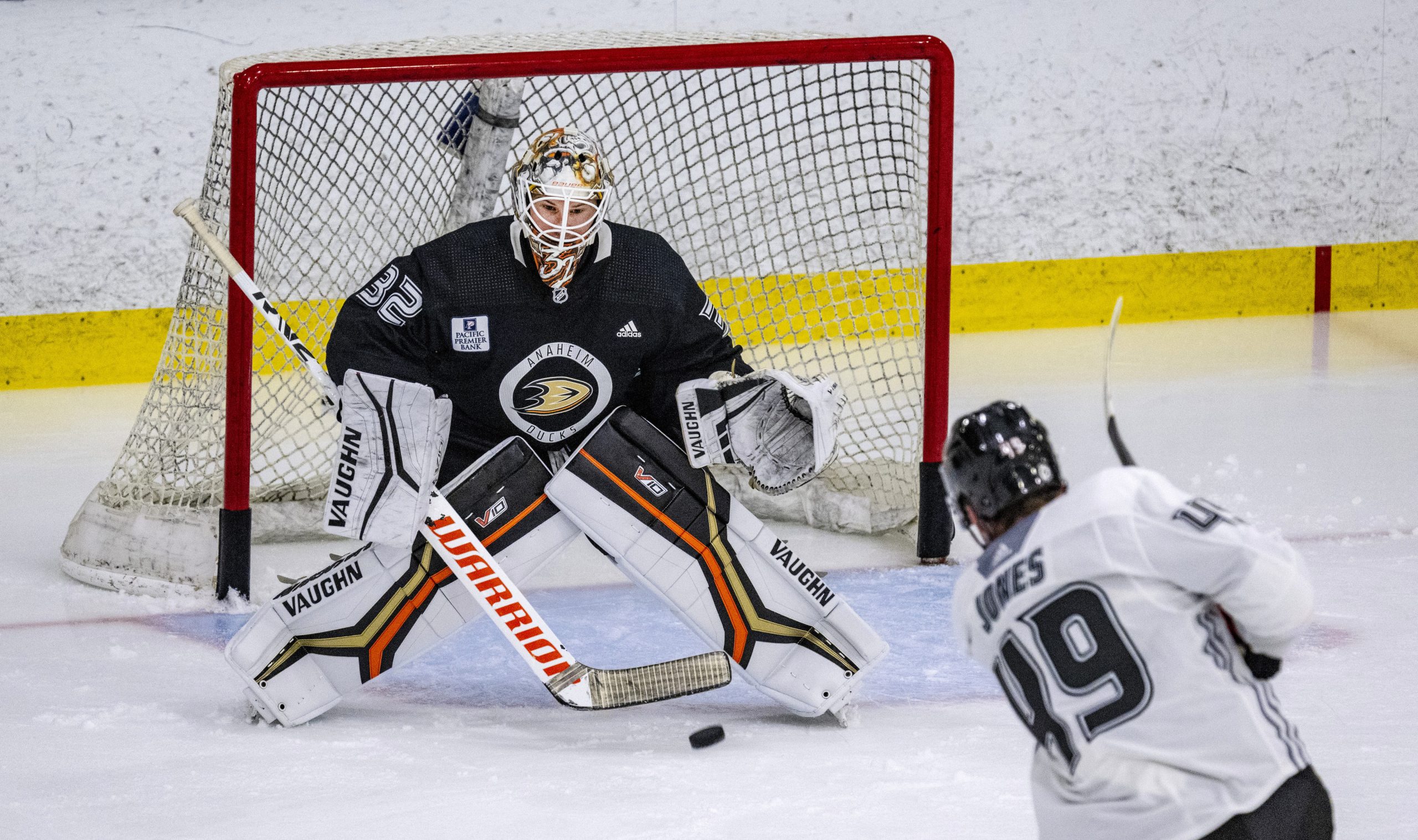 Ducks goaltender Alex Stalock looks to stop a shot on...