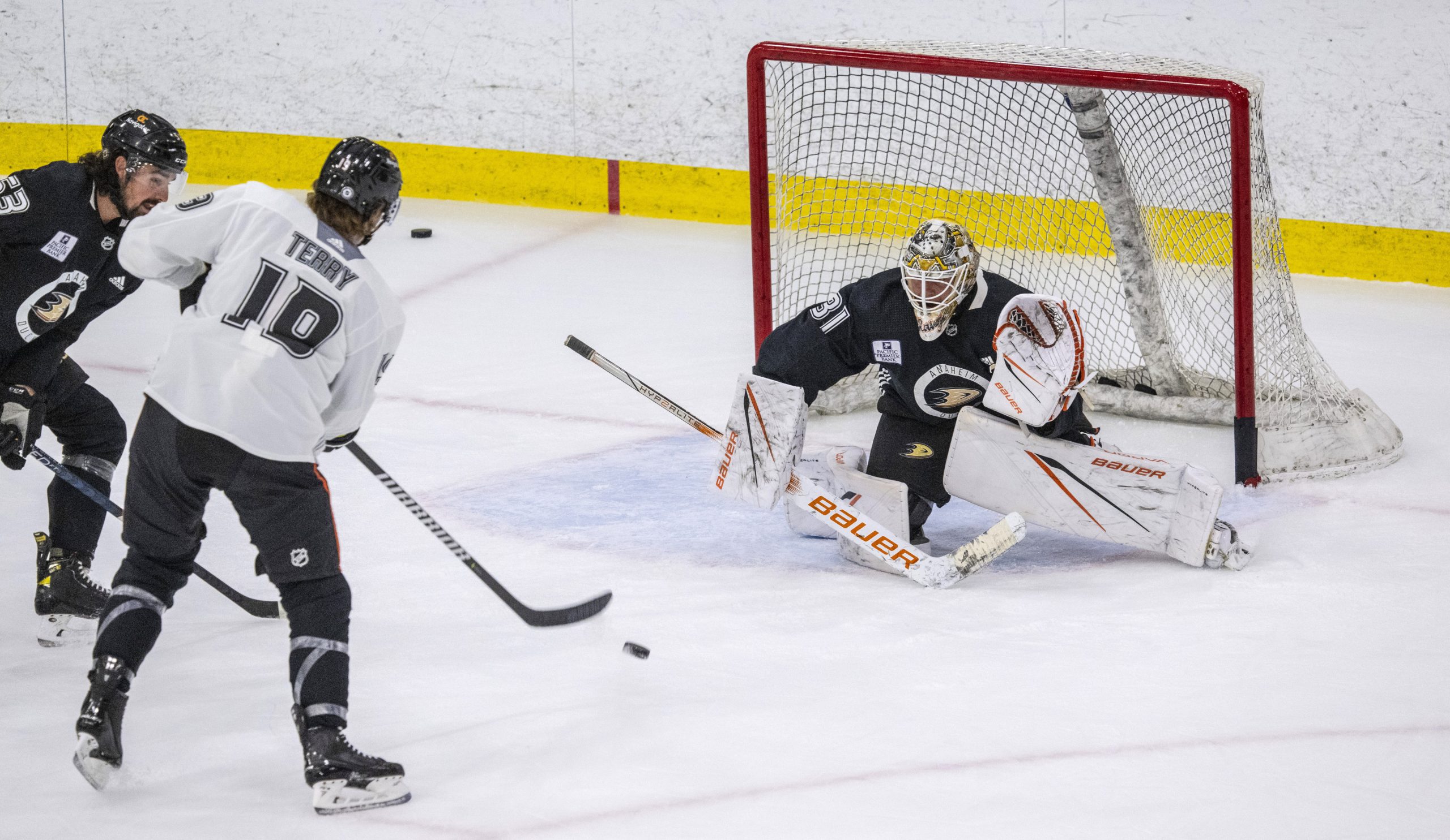 Ducks forward Troy Terry, center, takes a shot on goaltender...
