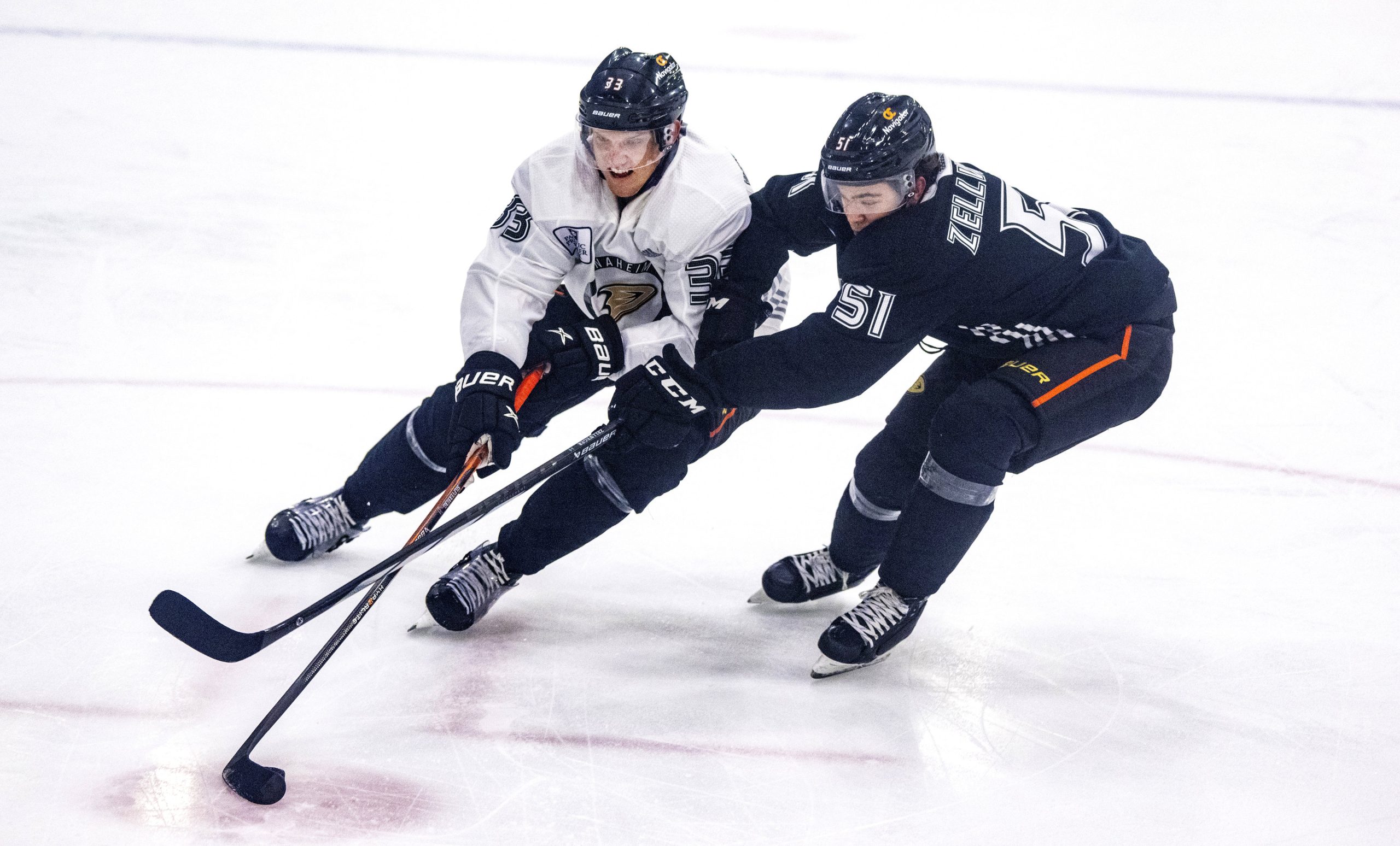 Ducks winger Jakob Silfverberg, left, attempts to keep the puck...