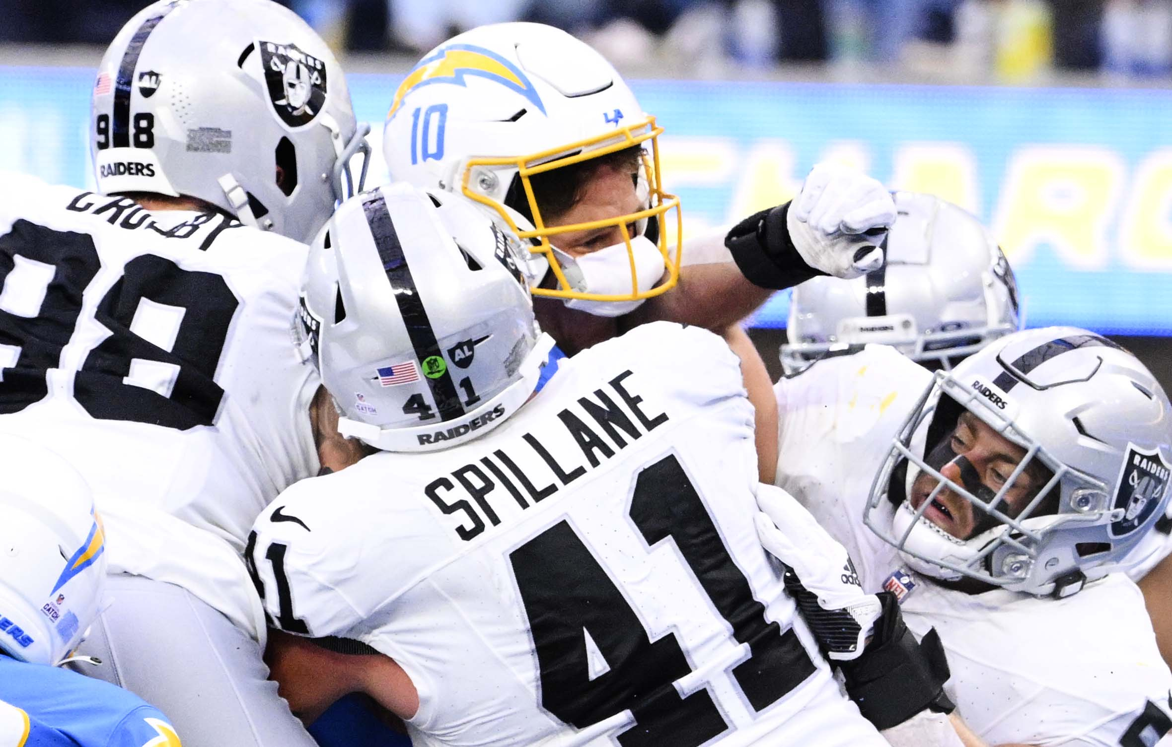 Quarterback Justin Herbert #10 of the Los Angeles Chargers reaches...