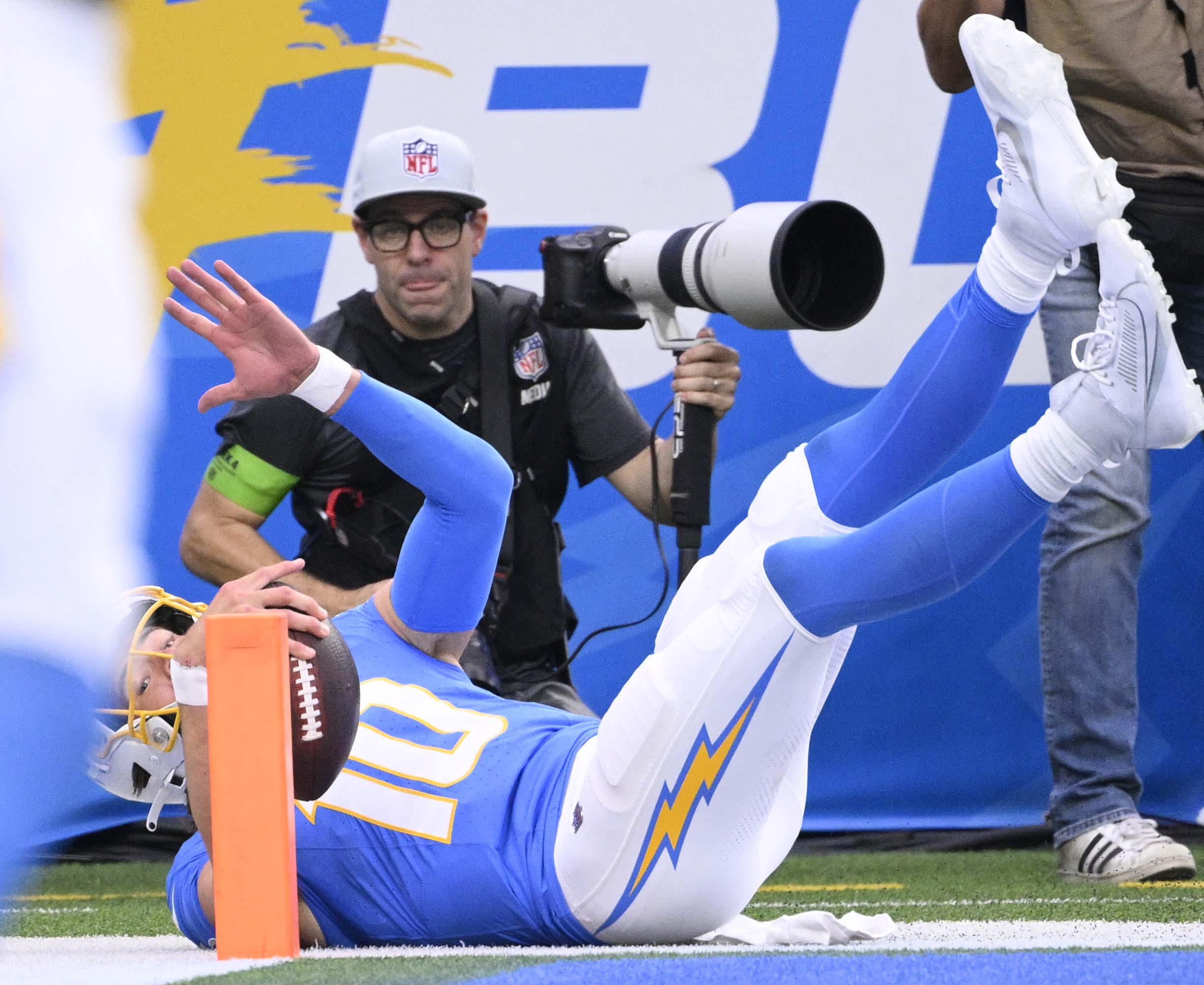 Quarterback Justin Herbert #10 of the Los Angeles Chargers runs...