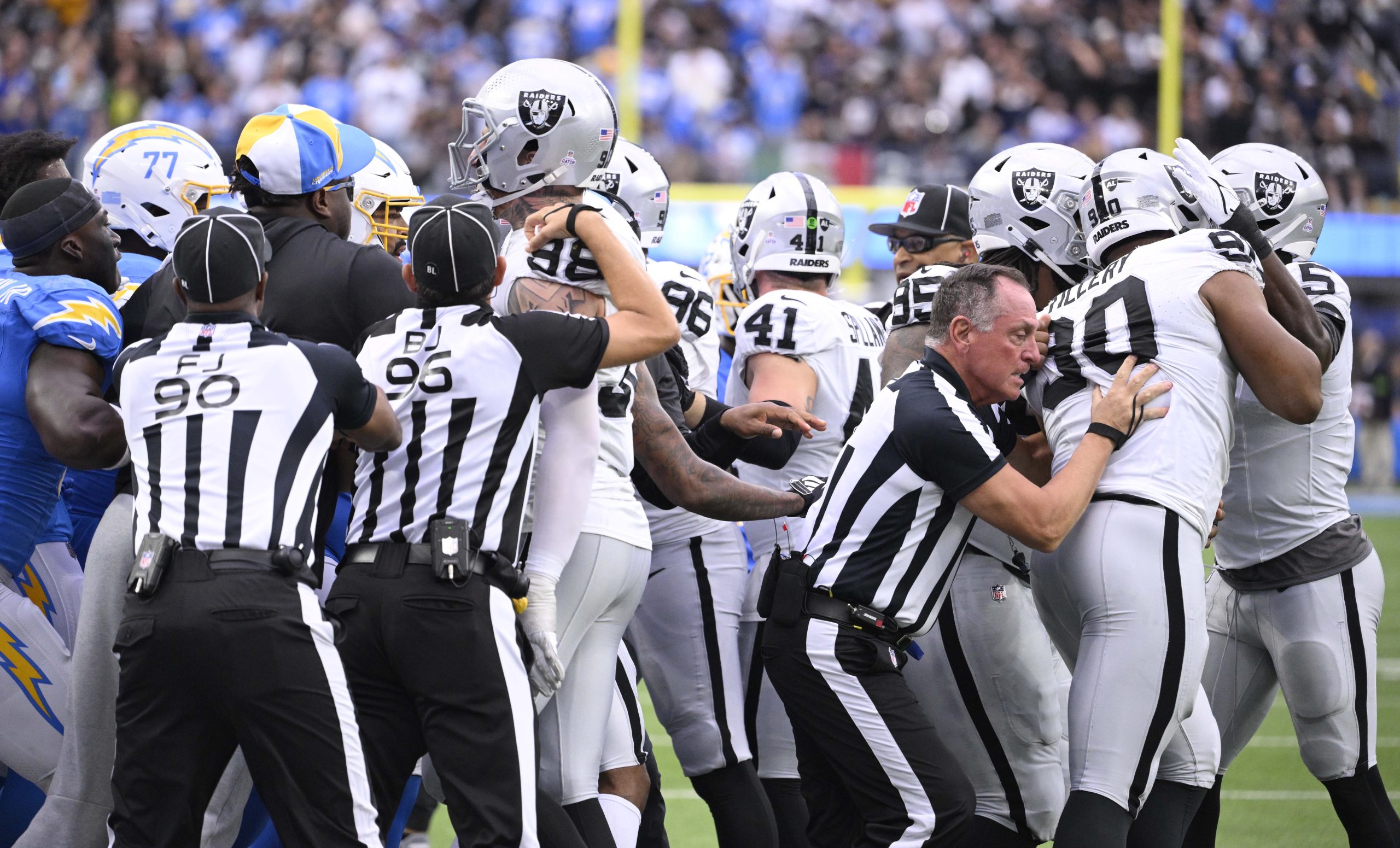 Los Angeles Chargers and Las Vegas Raiders scuffle in the...