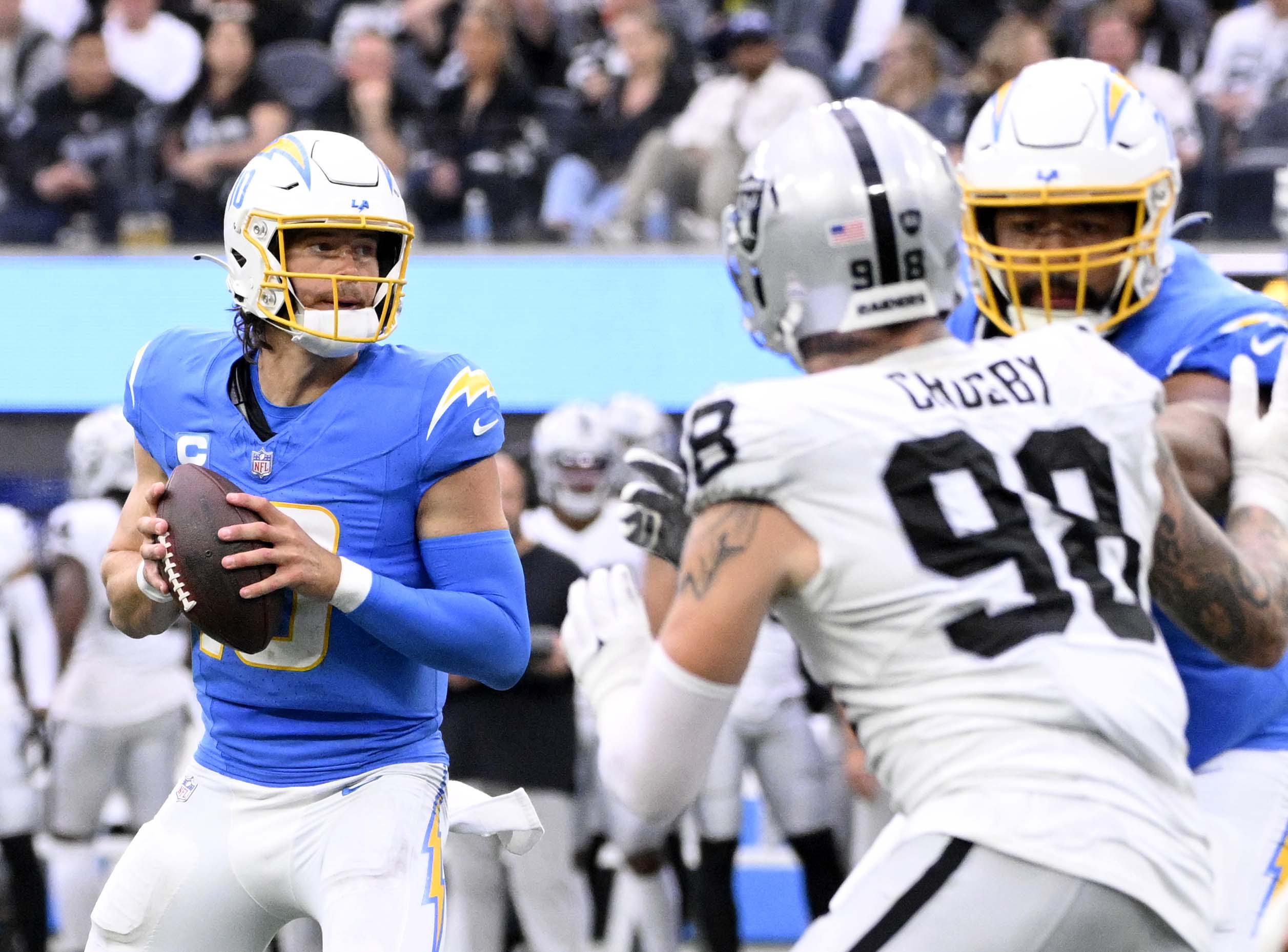 Quarterback Justin Herbert #10 of the Los Angeles Chargers drops...