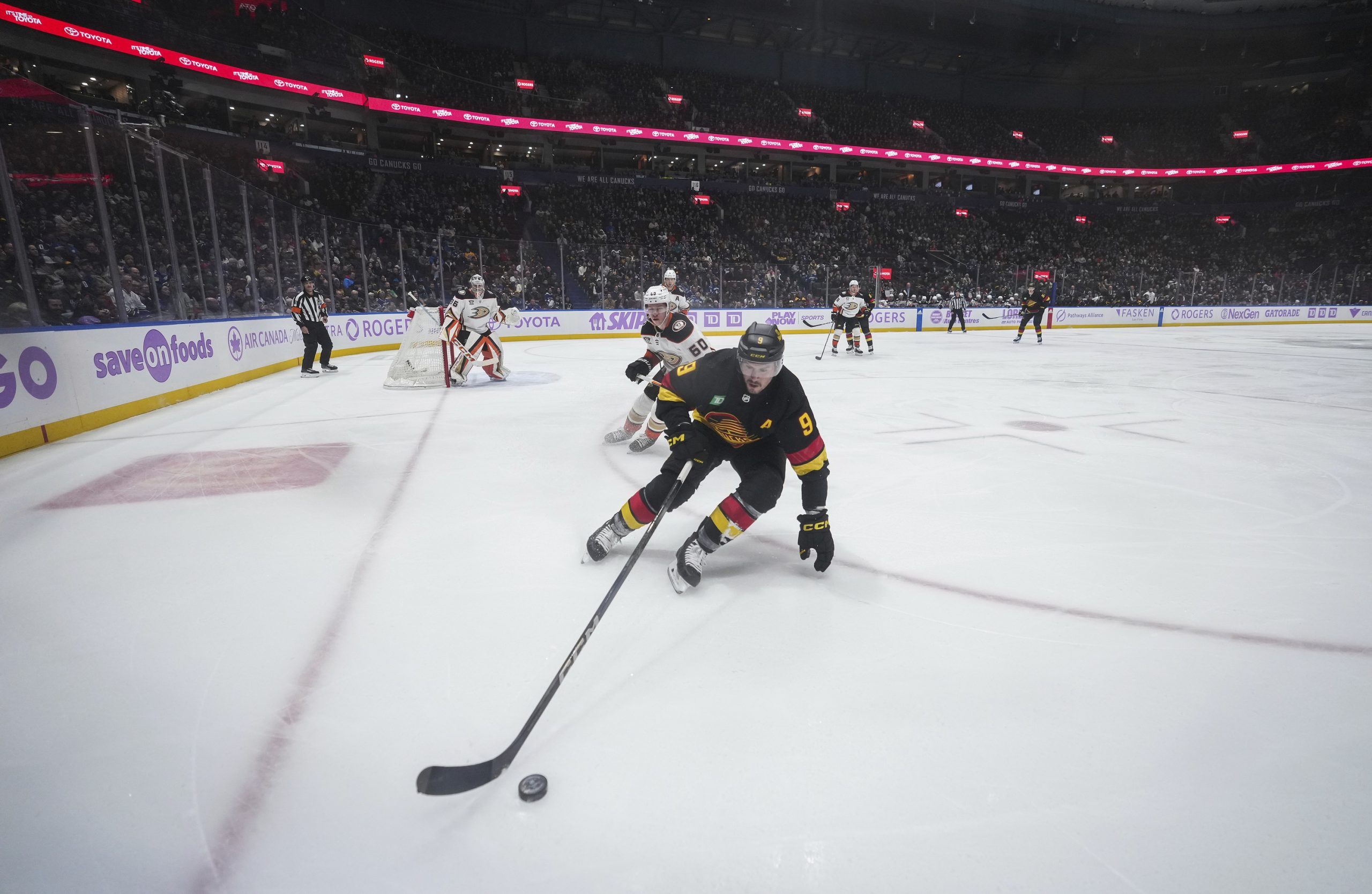 The Vancouver Canucks’ J.T. Miller skates with the puck while...
