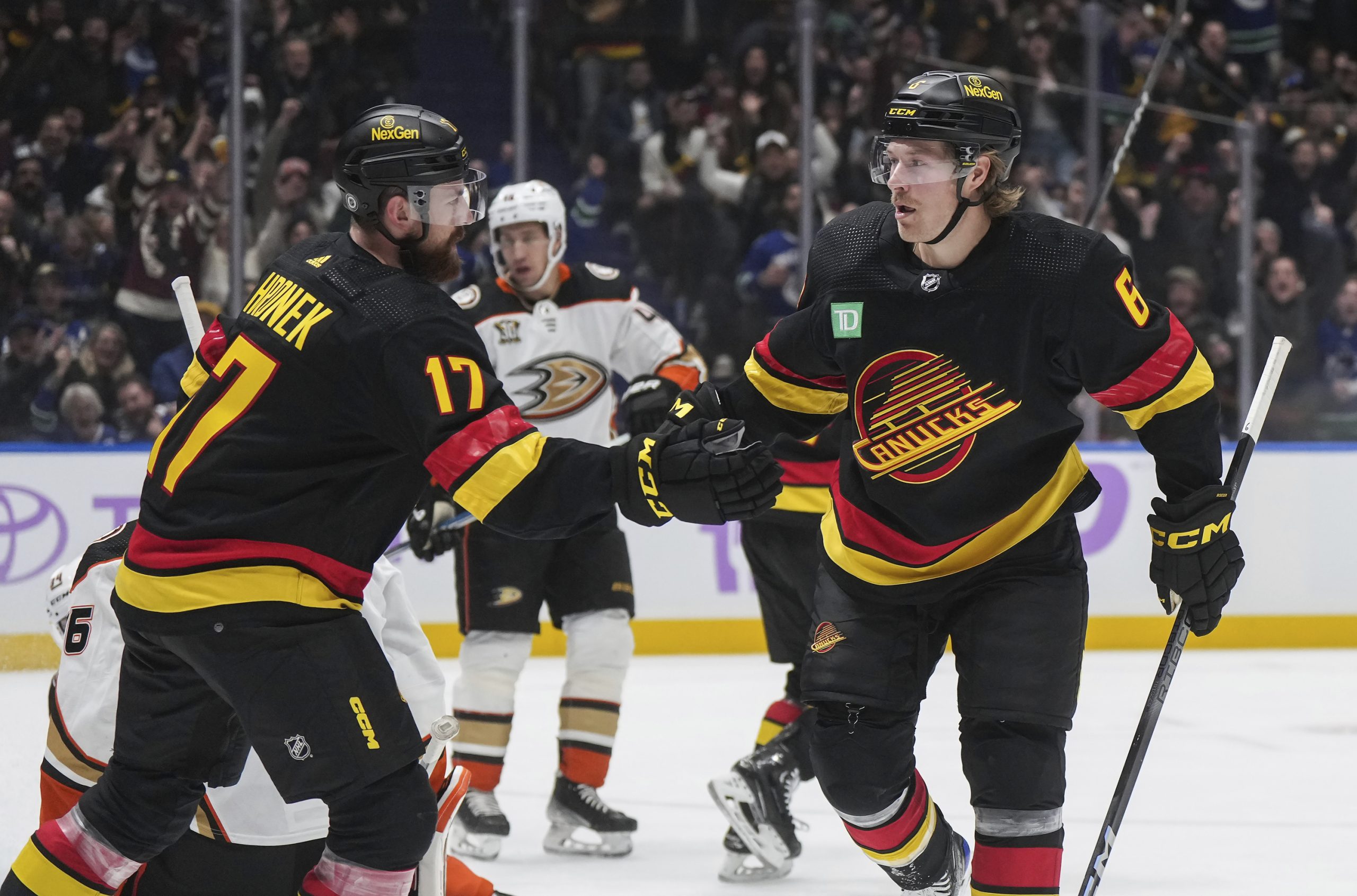 The Vancouver Canucks’ Brock Boeser, right, and Filip Hronek celebrate...