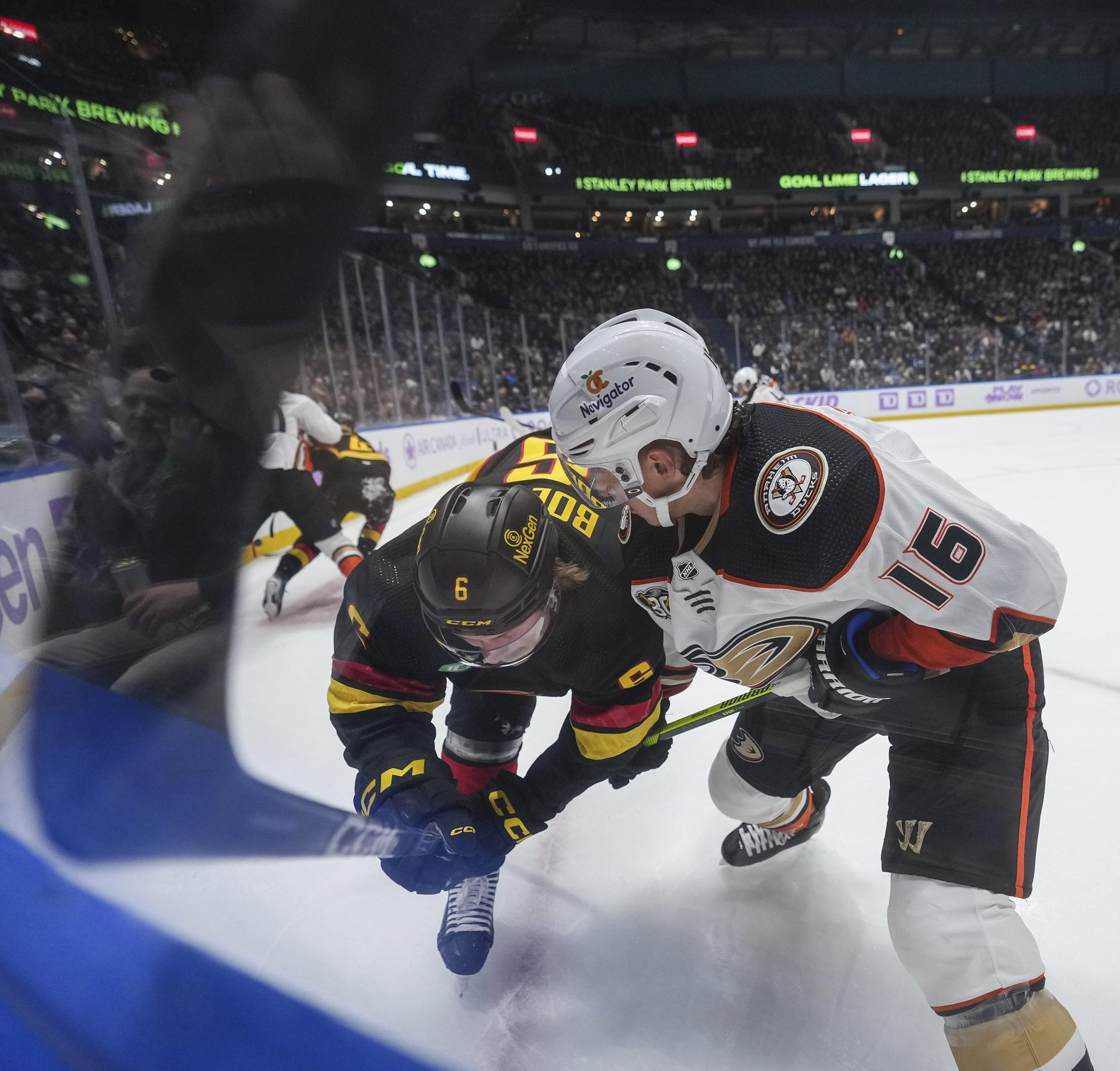 The Ducks’ Ryan Strome, right, checks the Vancouver Canucks’ Brock...