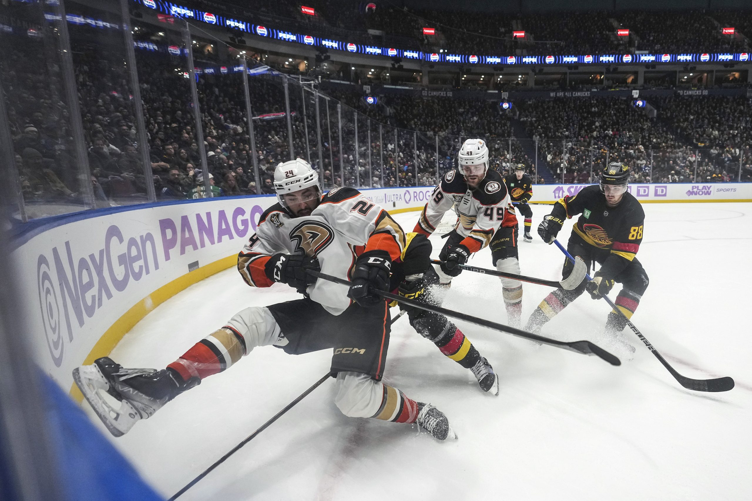 The Ducks’ Bo Groulx, left, falls while vying for the...