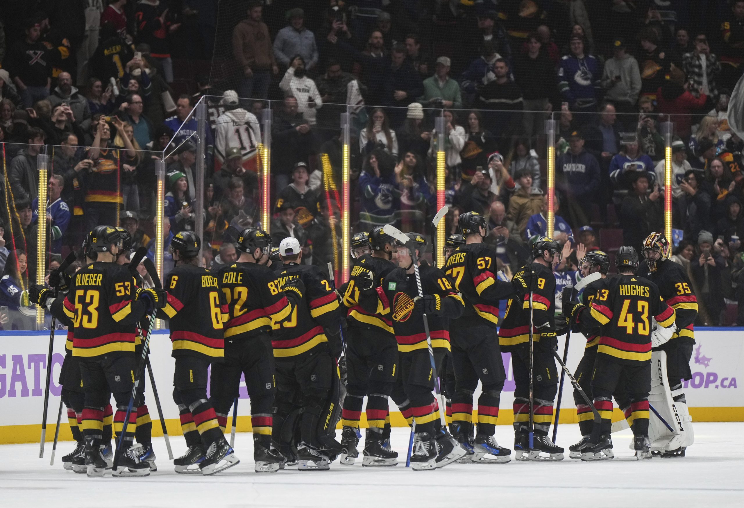 Vancouver Canucks players celebrate after their 3-1 victory over the...