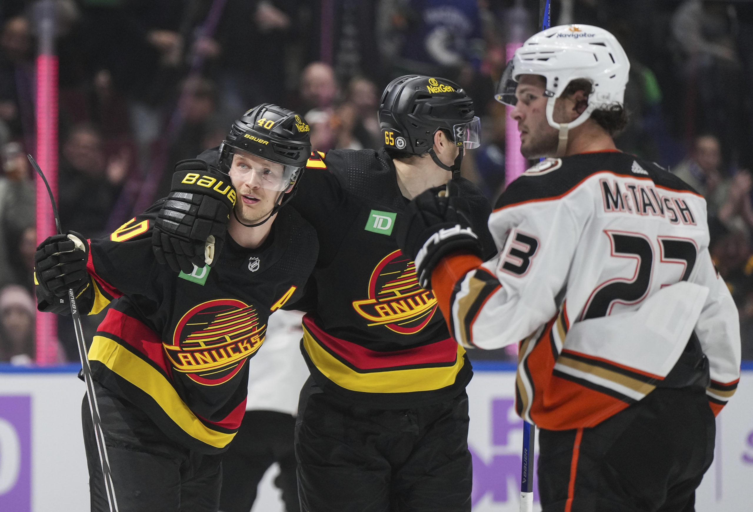 The Vancouver Canucks’ Elias Pettersson, left, and Ilya Mikheyev celebrate...