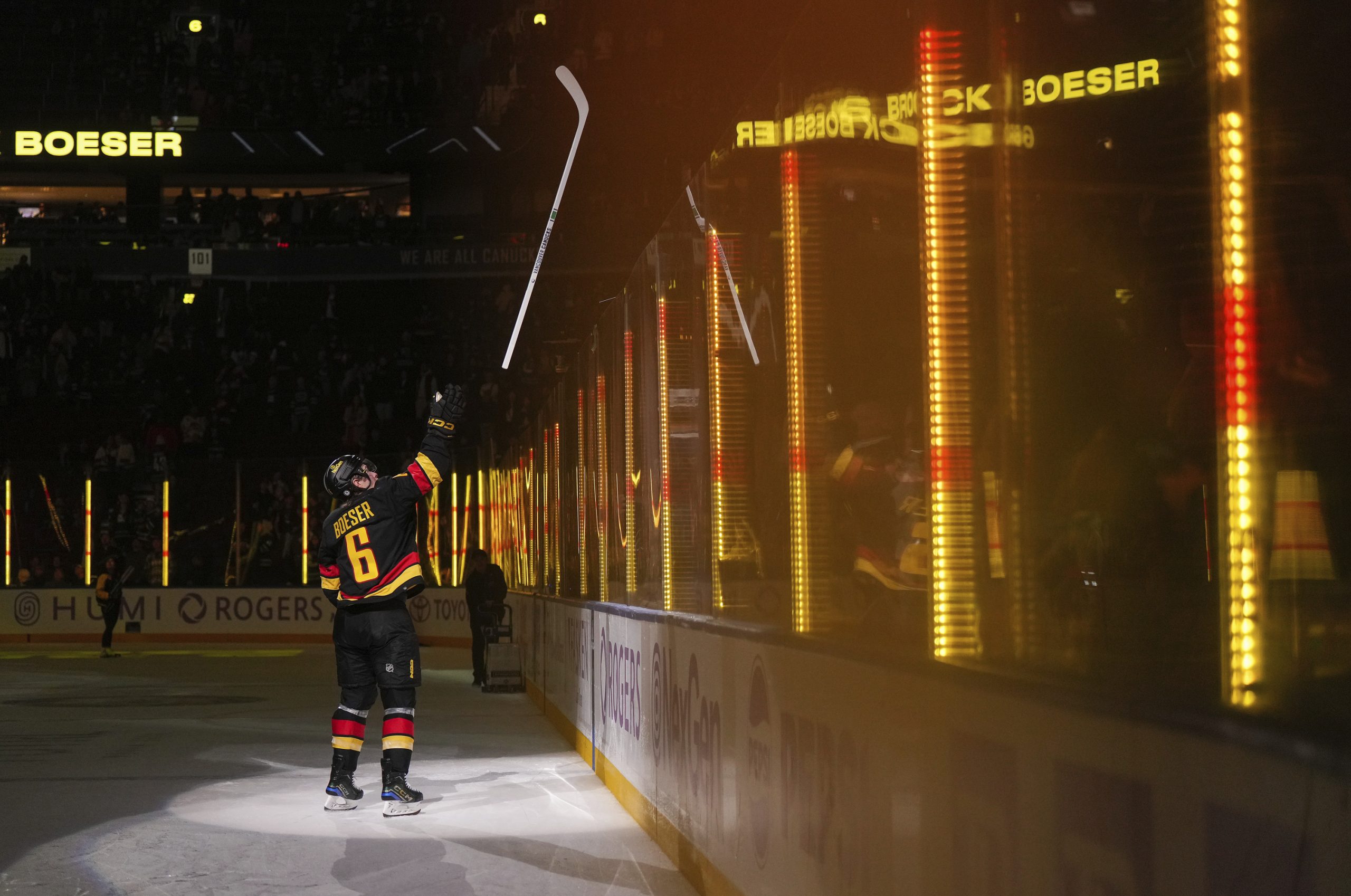 The Vancouver Canucks’ Brock Boeser tosses a stick into the...