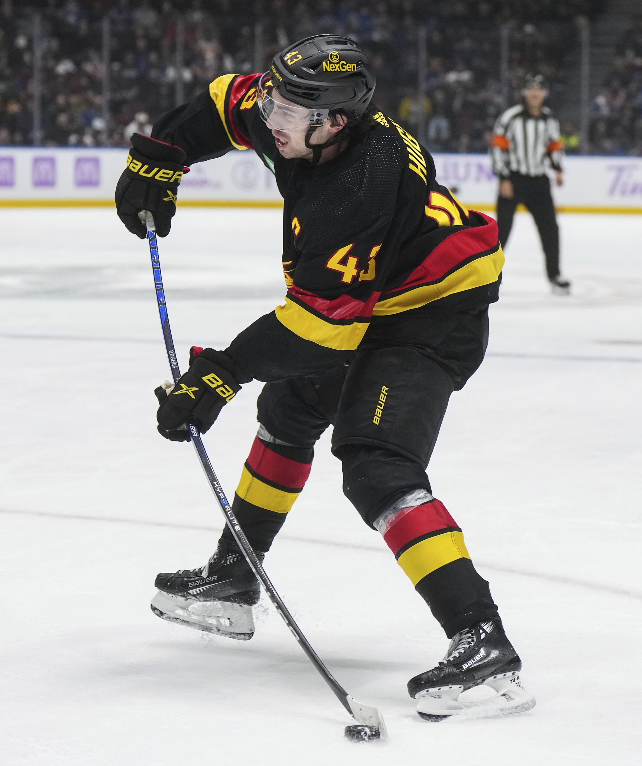 The Vancouver Canucks’ Quinn Hughes takes a shot on goal...
