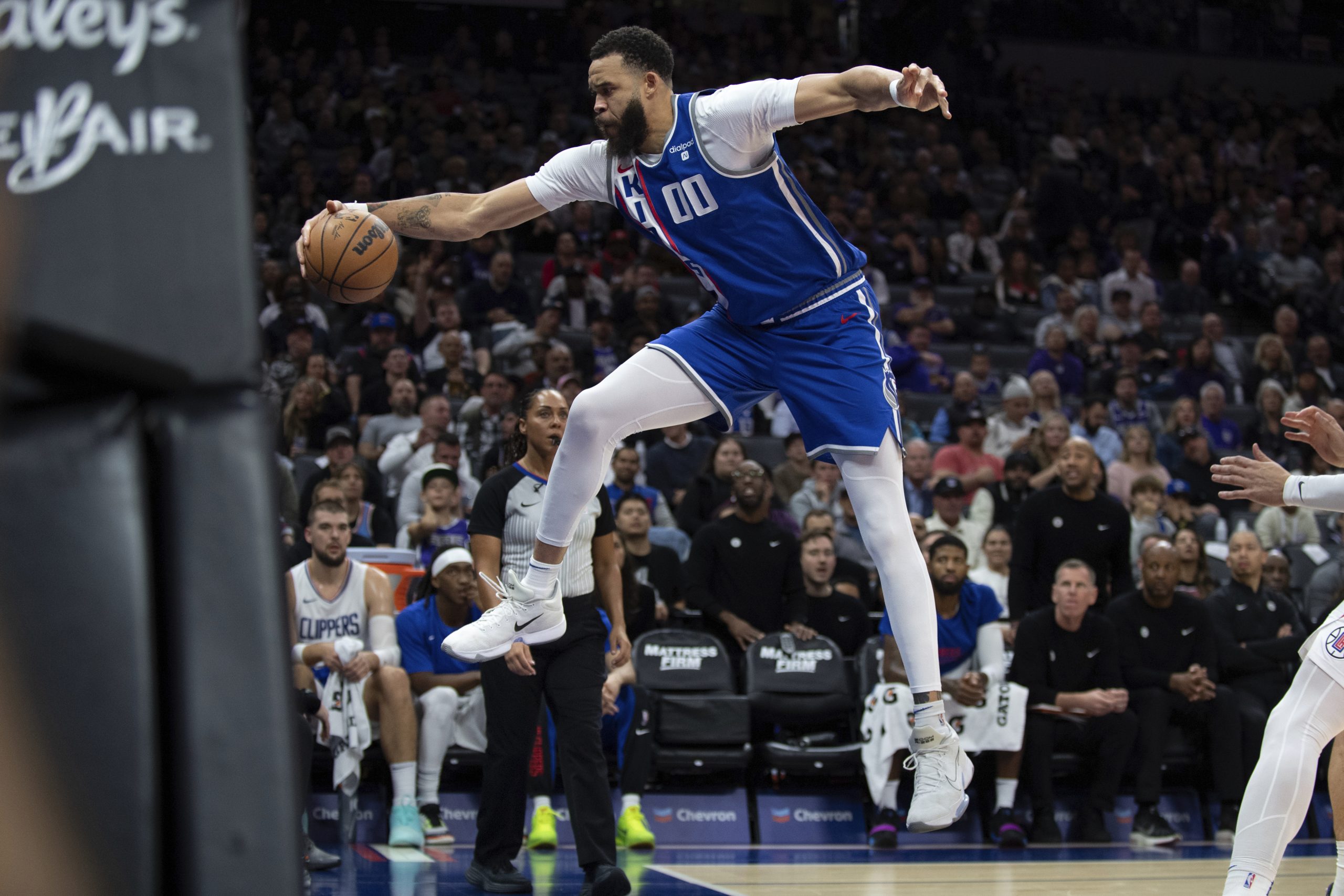 Sacramento Kings center JaVale McGee saves the ball from going...