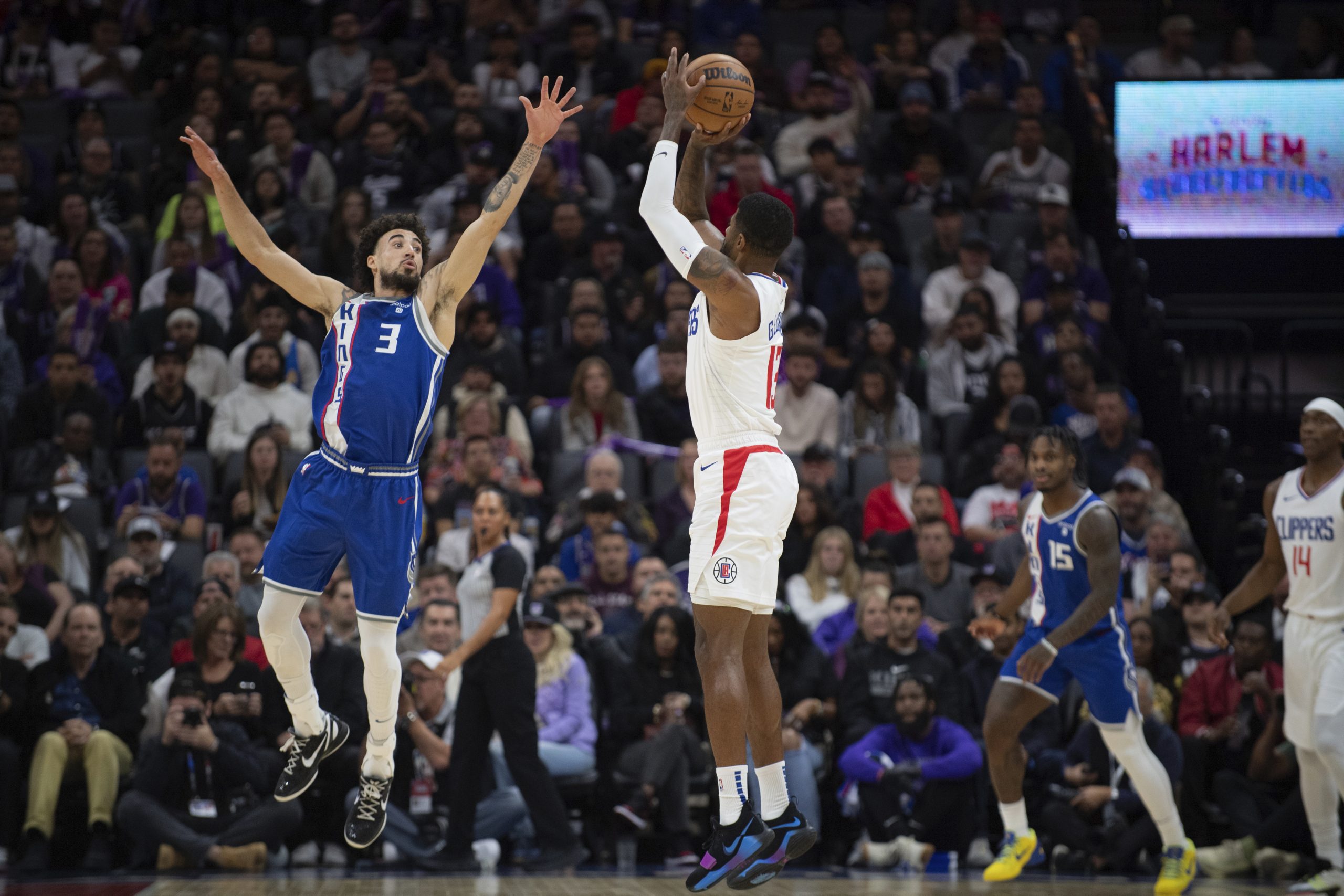 Clippers forward Paul George shoots over Sacramento Kings guard Chris...