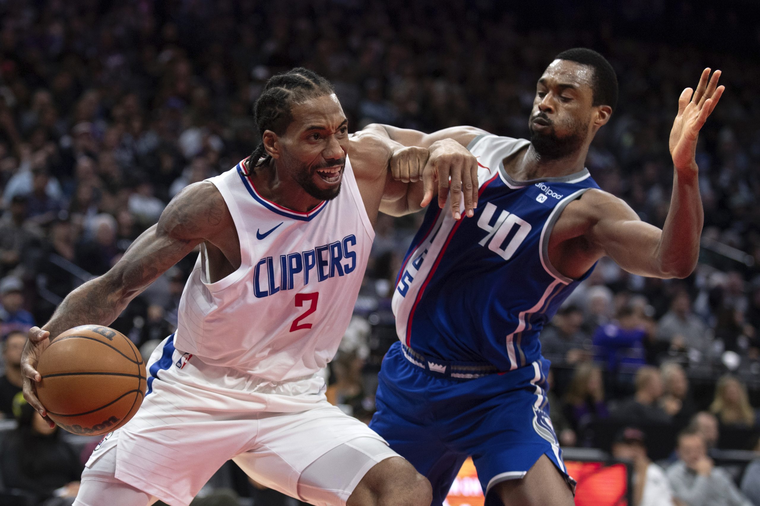 Clippers forward Kawhi Leonard handles the ball and works to...