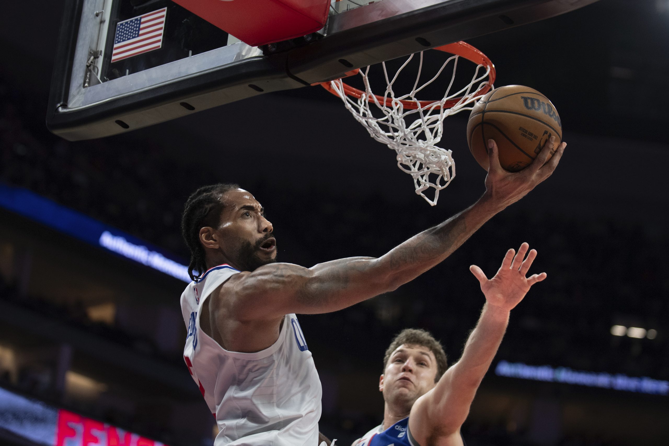 Clippers forward Kawhi Leonard, left, scores past Sacramento Kings forward...