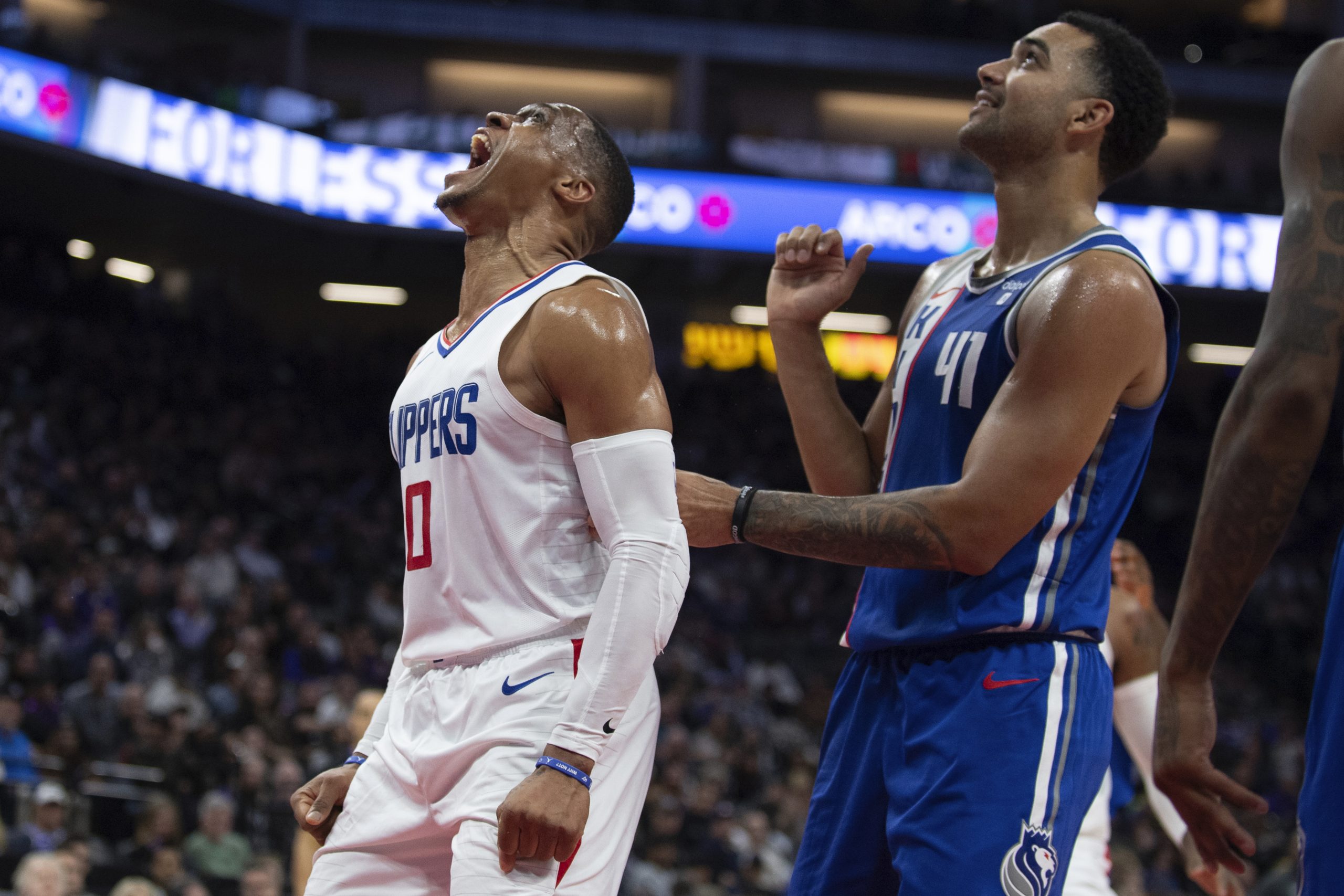 Clippers guard Russell Westbrook, left, lets out a yell after...