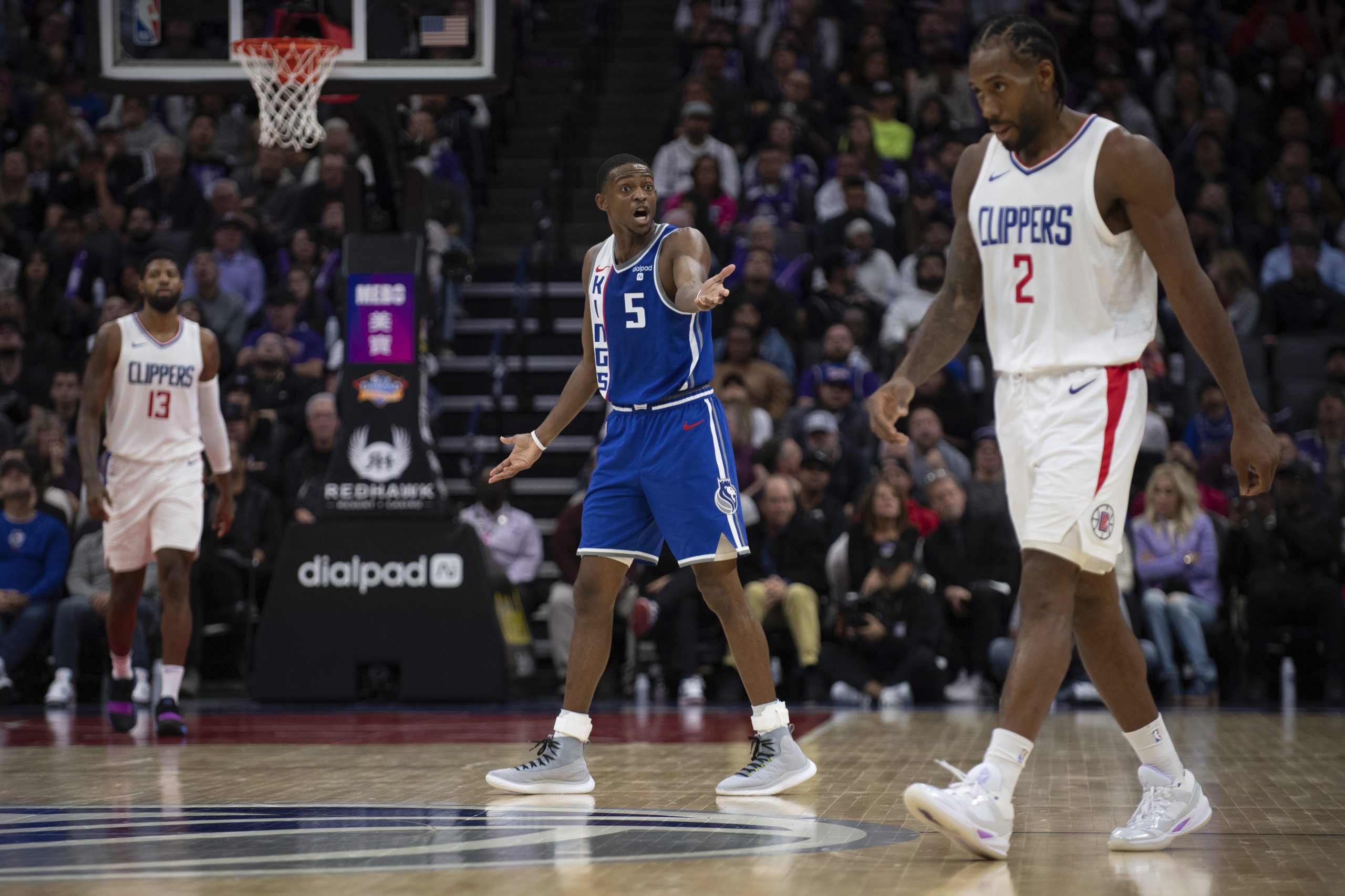 Sacramento Kings guard De’Aaron Fox, center, pleads his case to...