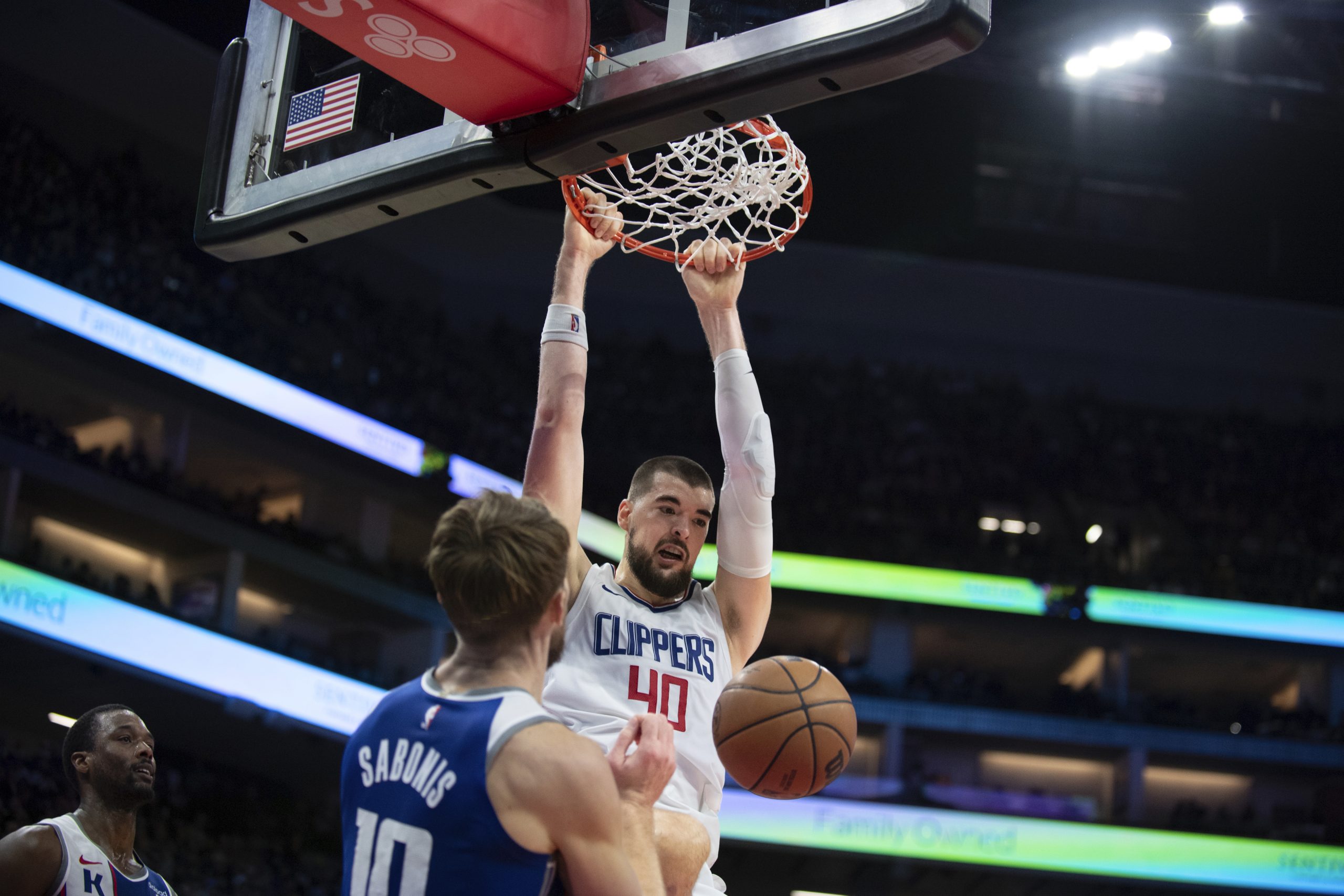 Clippers center Ivica Zubac dunks over Sacramento Kings forward Domantas...