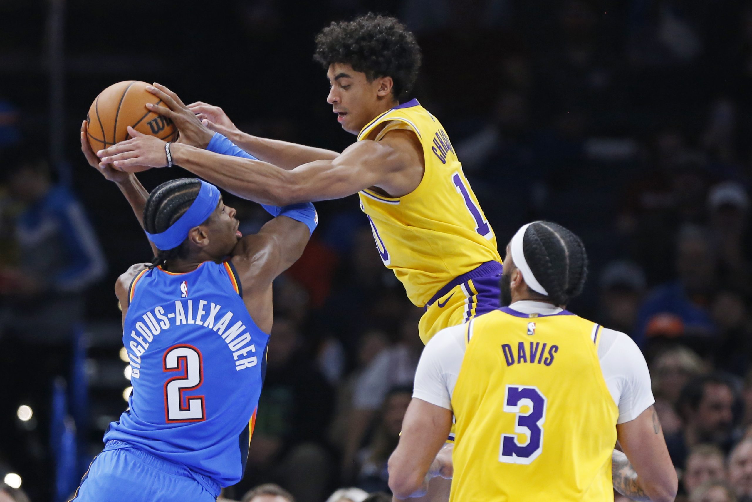Oklahoma City Thunder guard Shai Gilgeous-Alexander, left, tries to score...