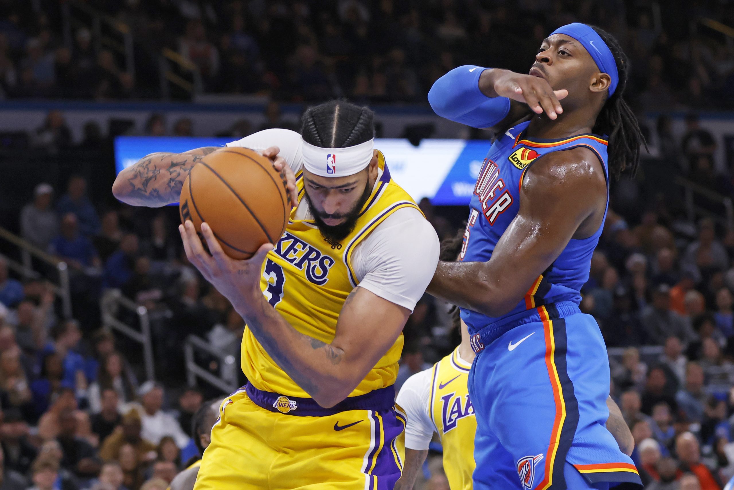 Lakers forward Anthony Davis, left, grabs a rebound next to...