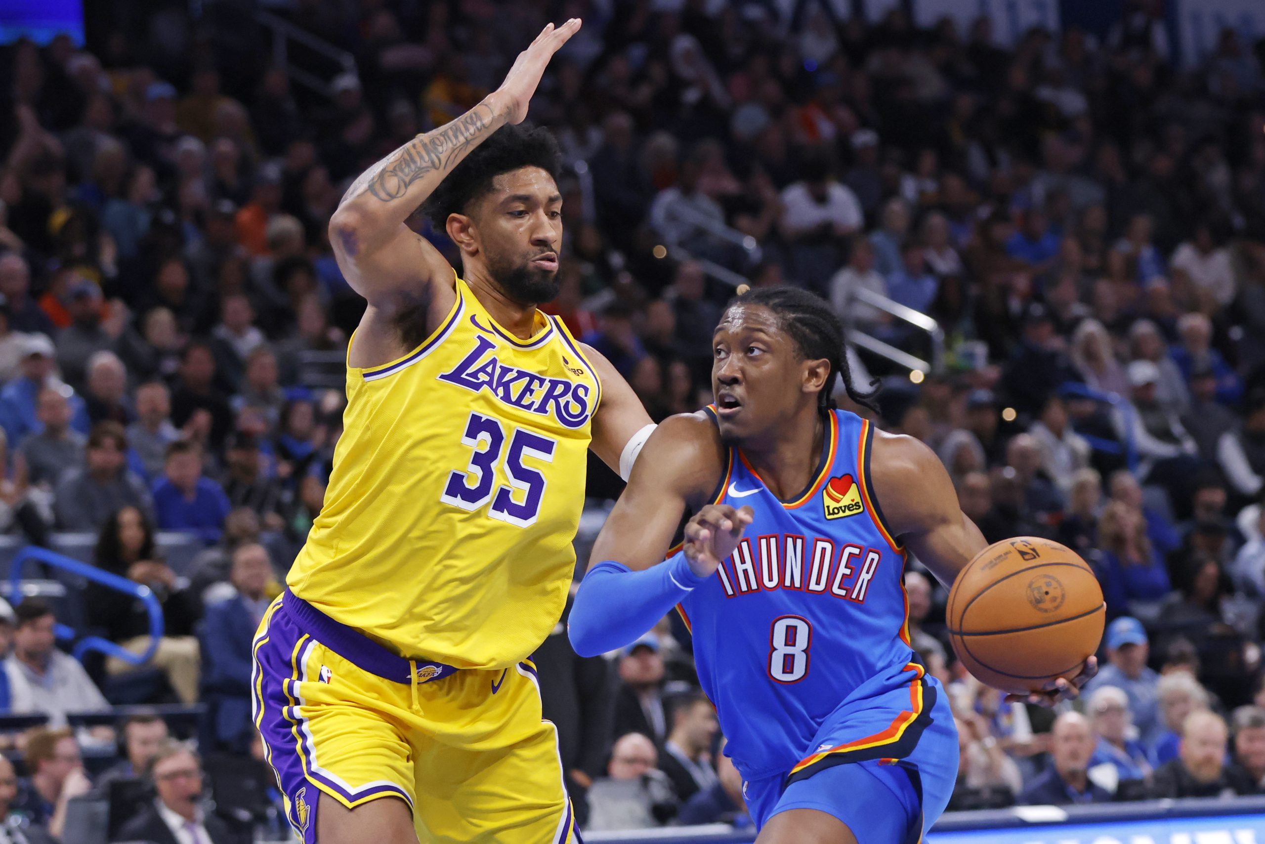Oklahoma City Thunder forward Jalen Williams drives against Lakers forward...