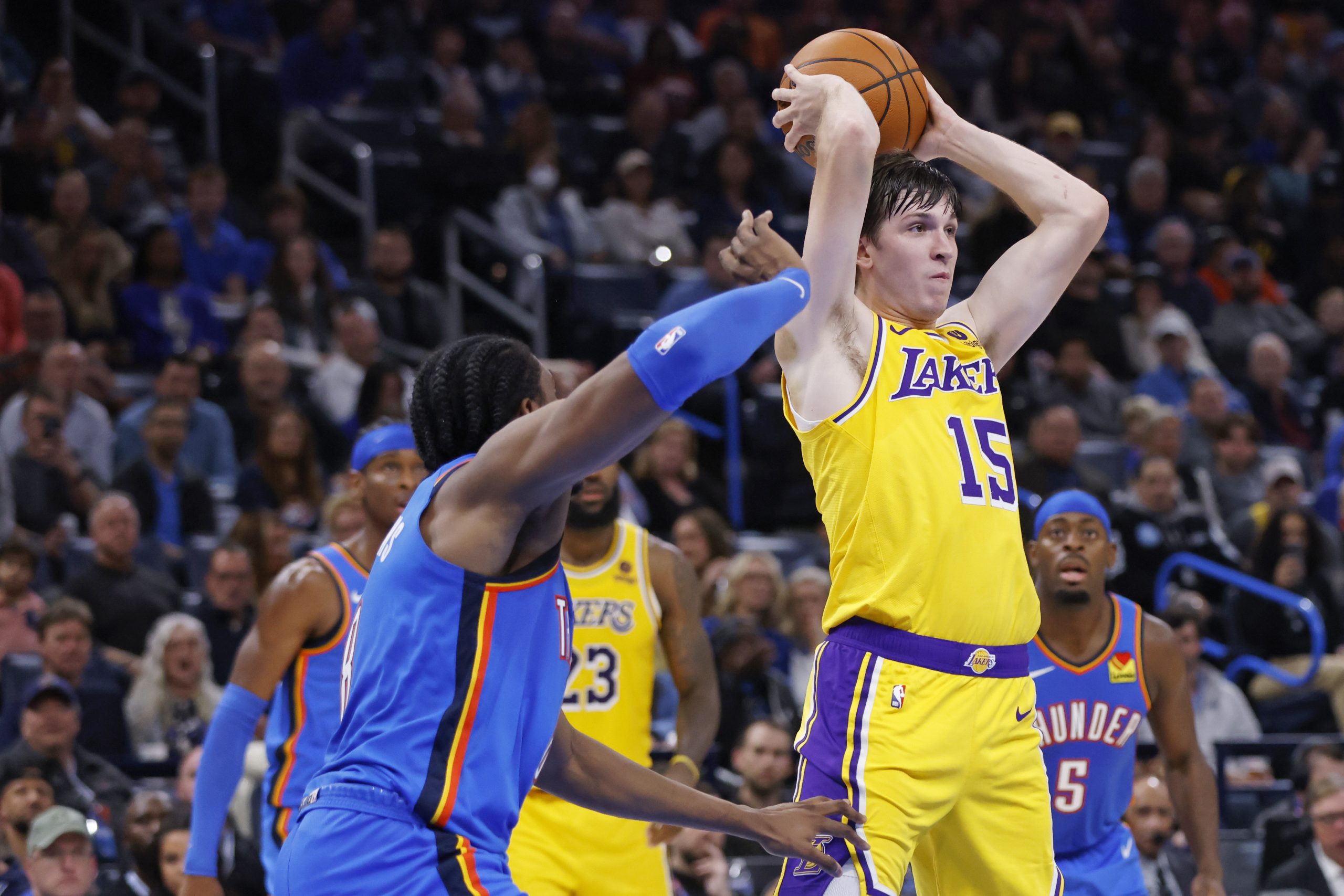 Lakers guard Austin Reaves passes the ball away from Oklahoma...