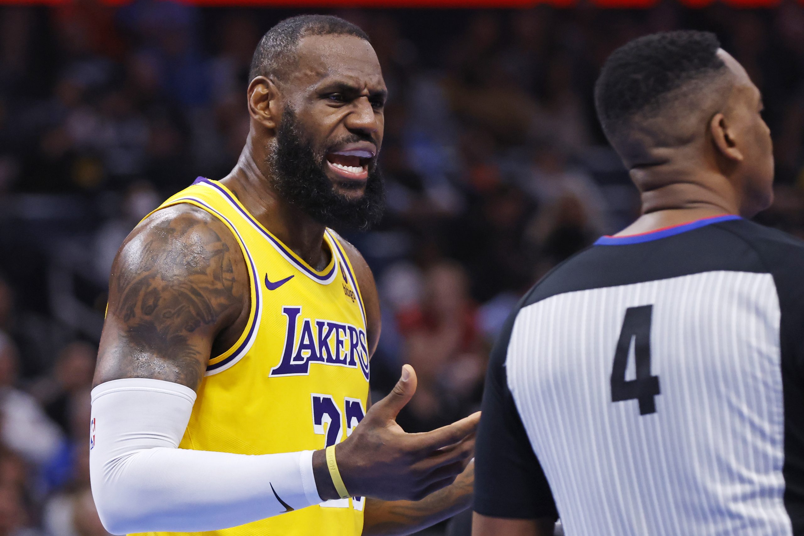 Lakers forward LeBron James, left, questions referee Sean Wright about...