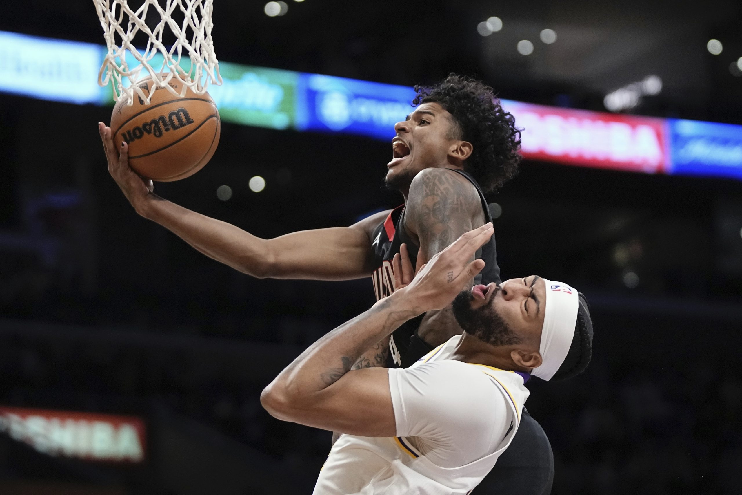 Houston Rockets guard Jalen Green, top, shoots as Los Angeles...