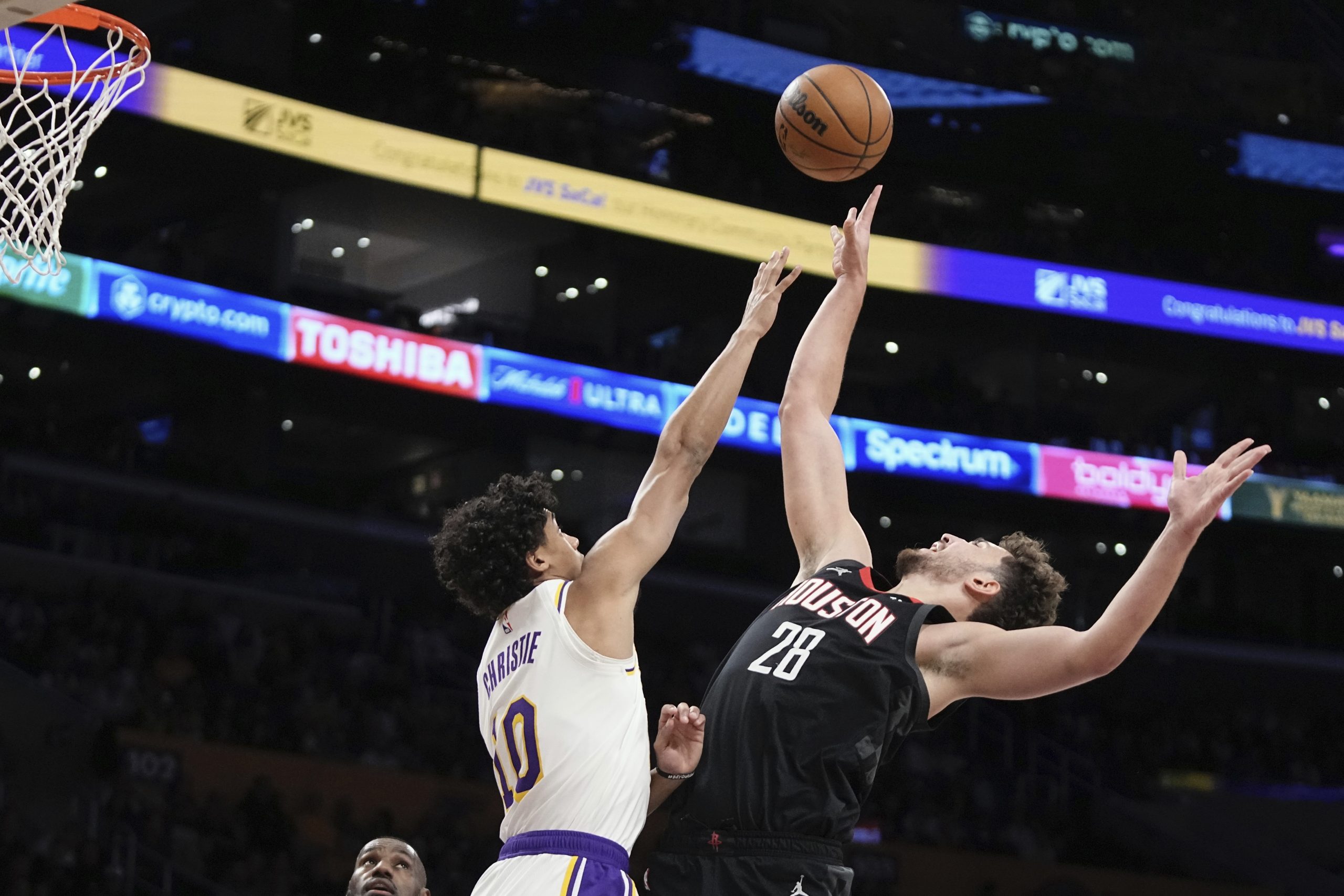 Houston Rockets center Alperen Sengun, right, shoots as Los Angeles...